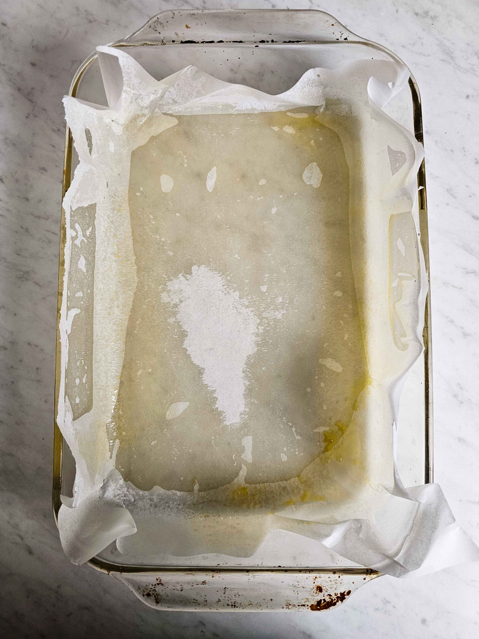 PREHEAT THE OVEN TO 350 AND LINE THE BAKING PAN WITH PARCHMENT PAPER