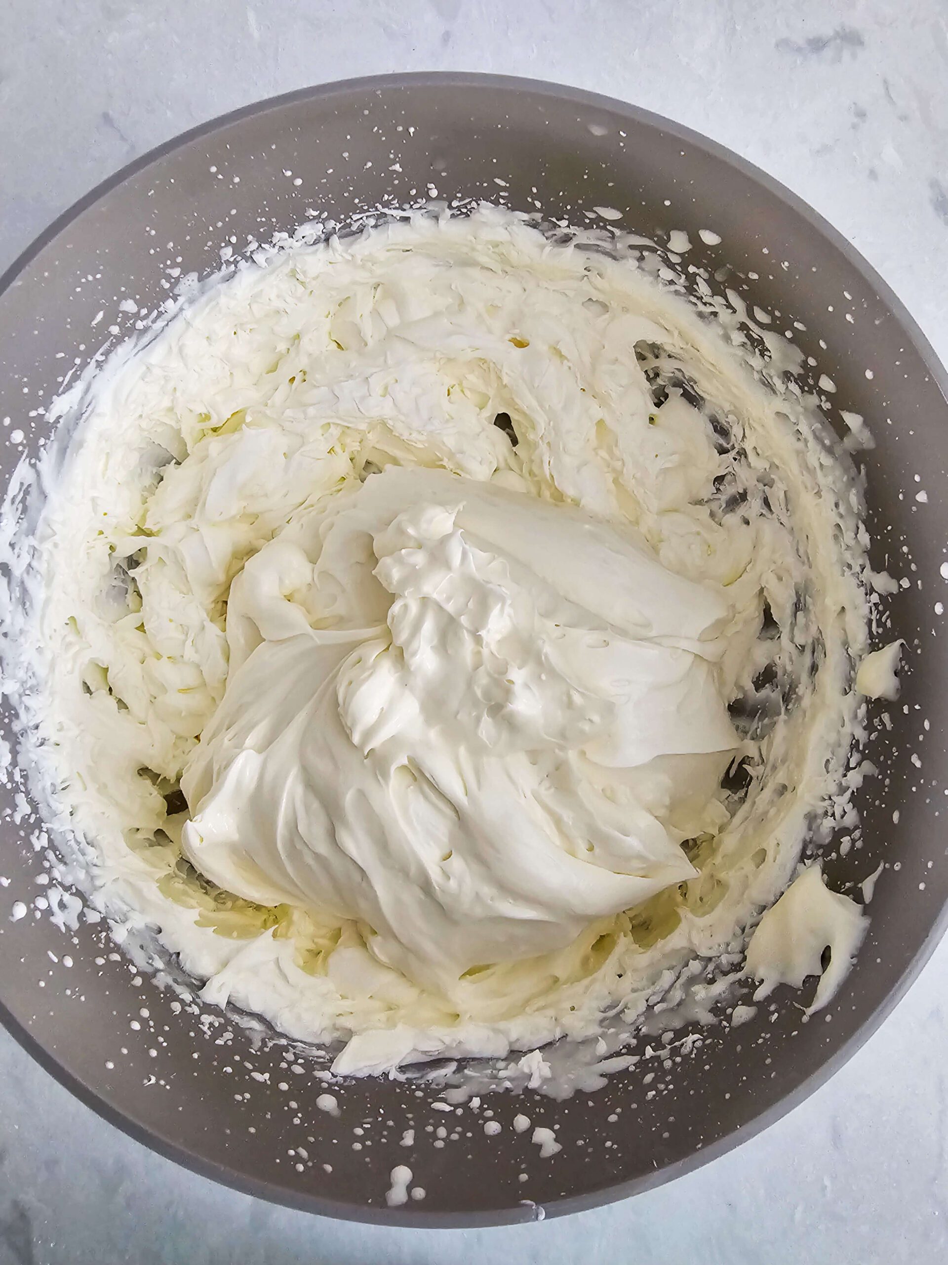 WHIP THE HEAVY CREAM WITH A HAND MIXER UNITL YOU REACH STIFF PEAKS