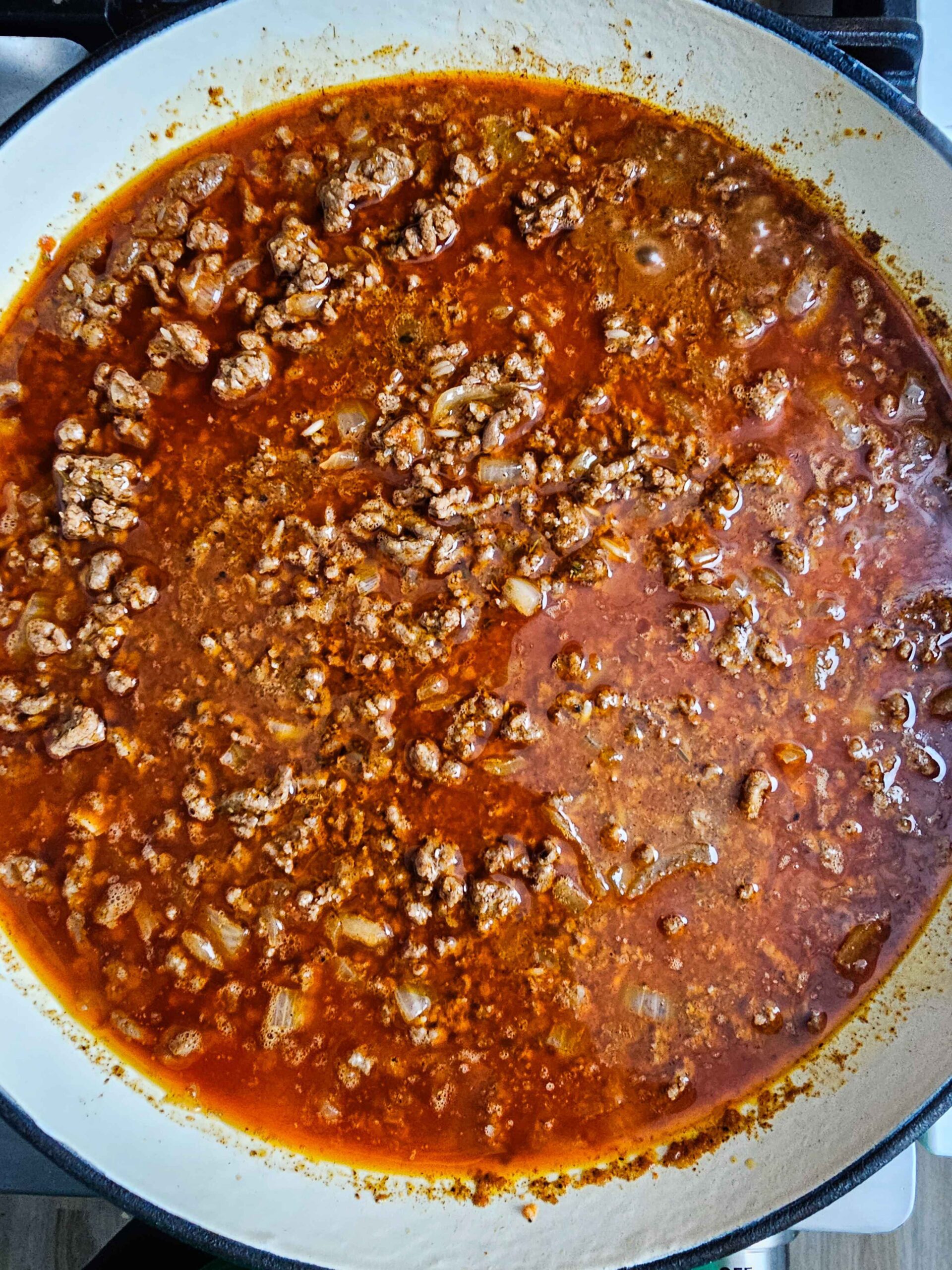 ADD THE ROTEL, RICE AND CHICKEN STOCK - COVER AND SIMMER ON LOW FOR 20-25 MINUTES