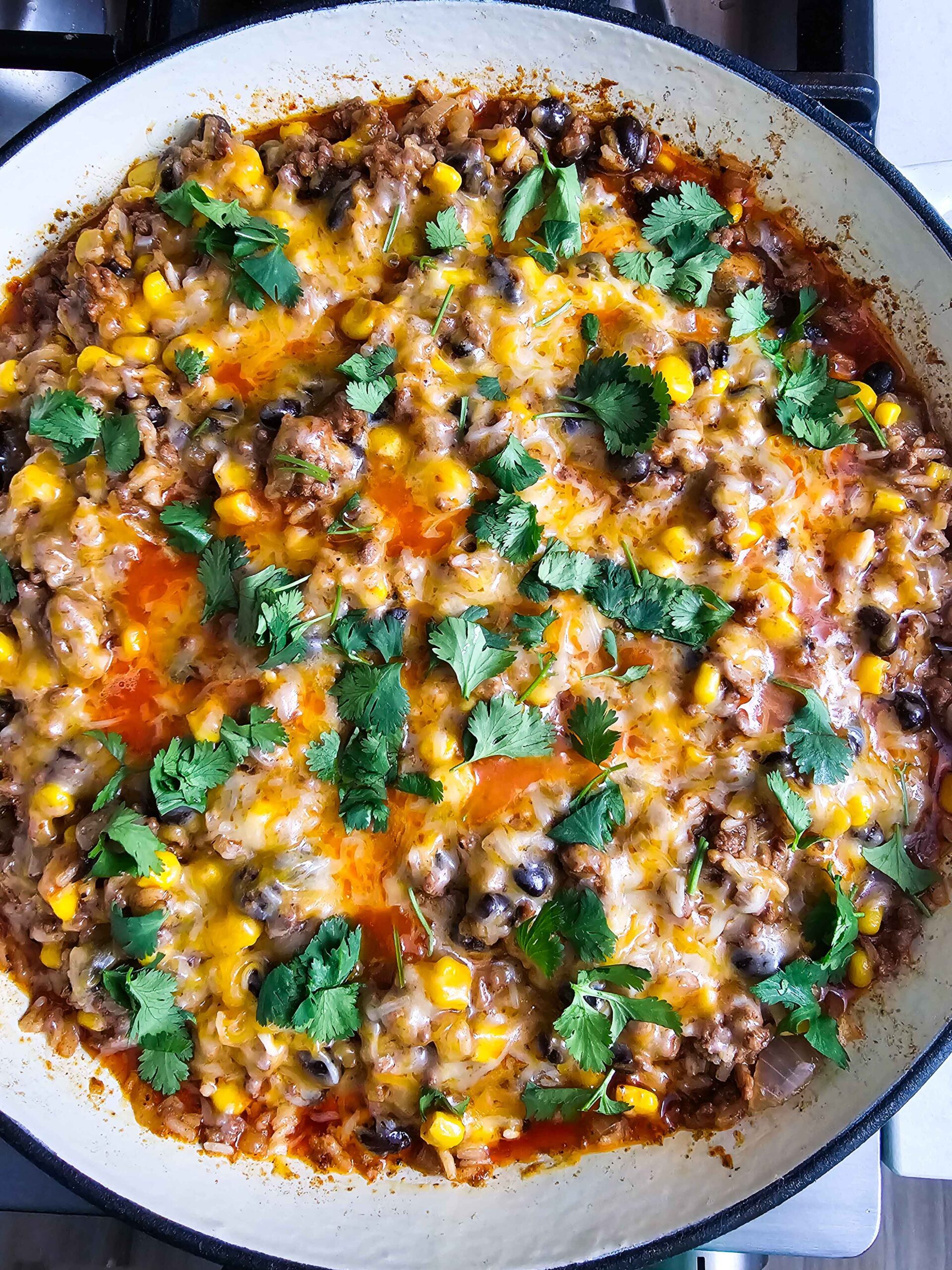 ADD THE MEXICAN CHEESE AND CILANTRO TO THE SKILLET