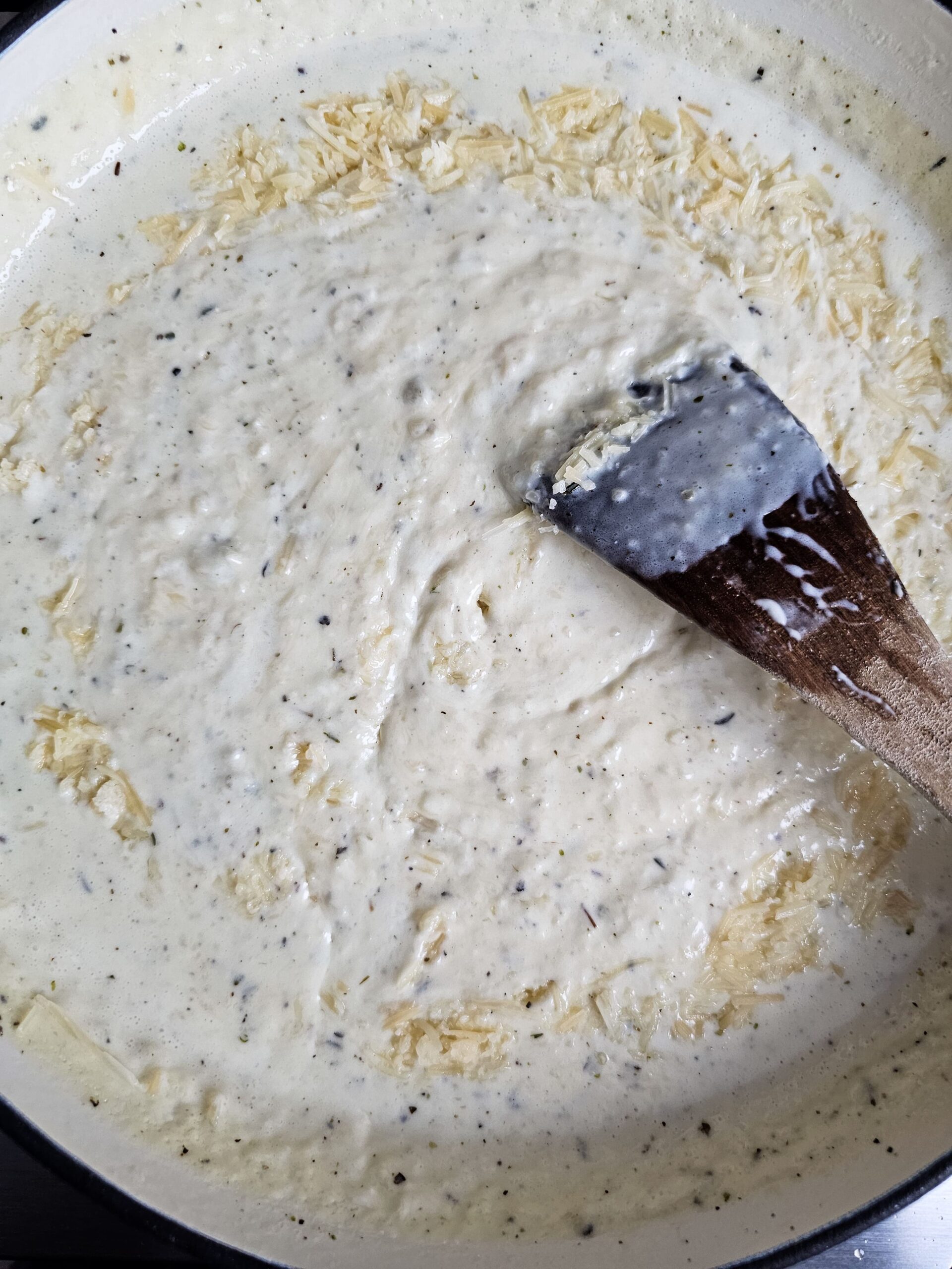 ADD THE CHICKEN BROTH AND HEAVY CREAM AND PARMESAN CHEESE