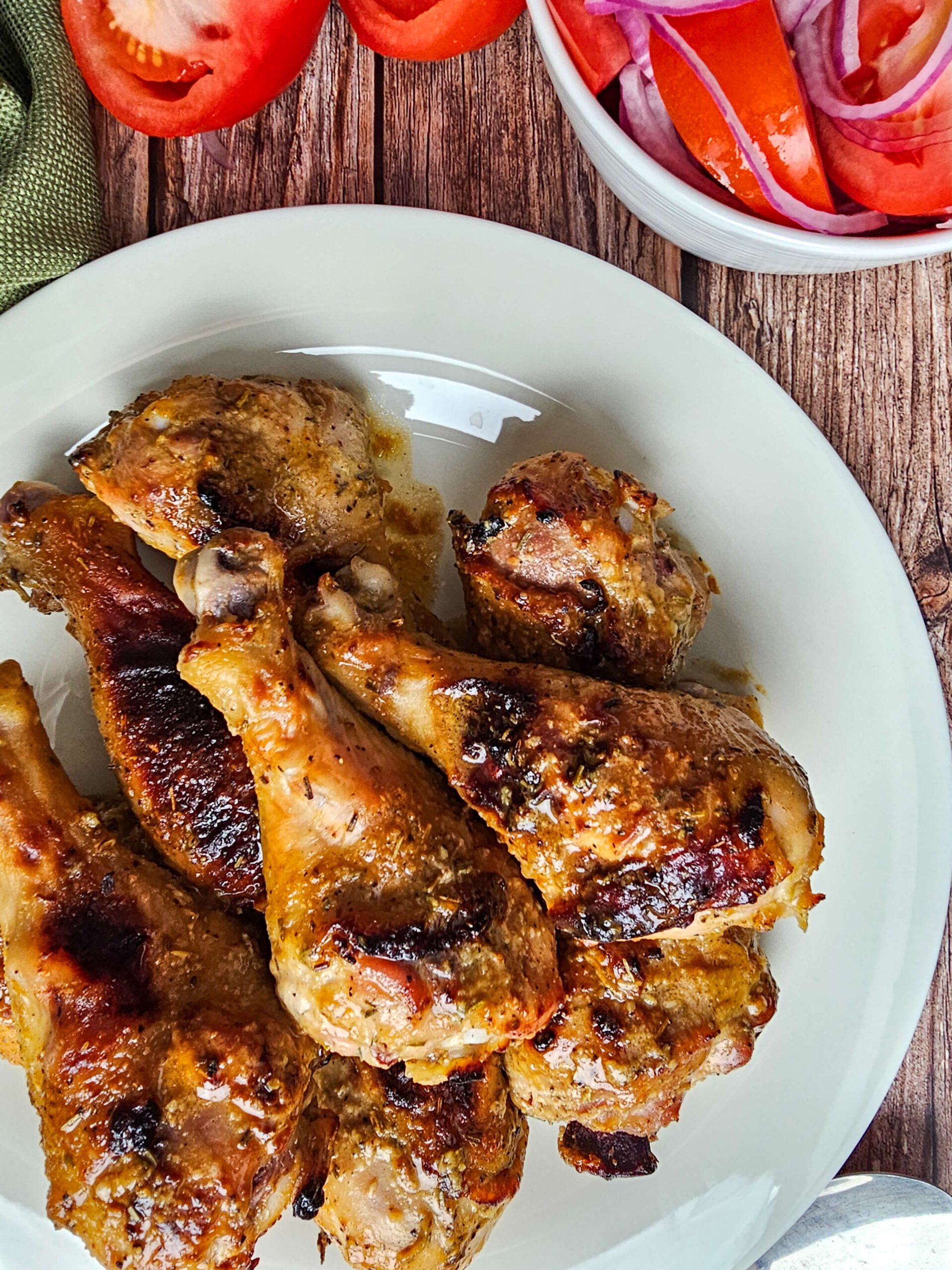 SERVE AND ENJOY CHICKEN LEGS SERVED WITH MARINATED TOMATO SALAD