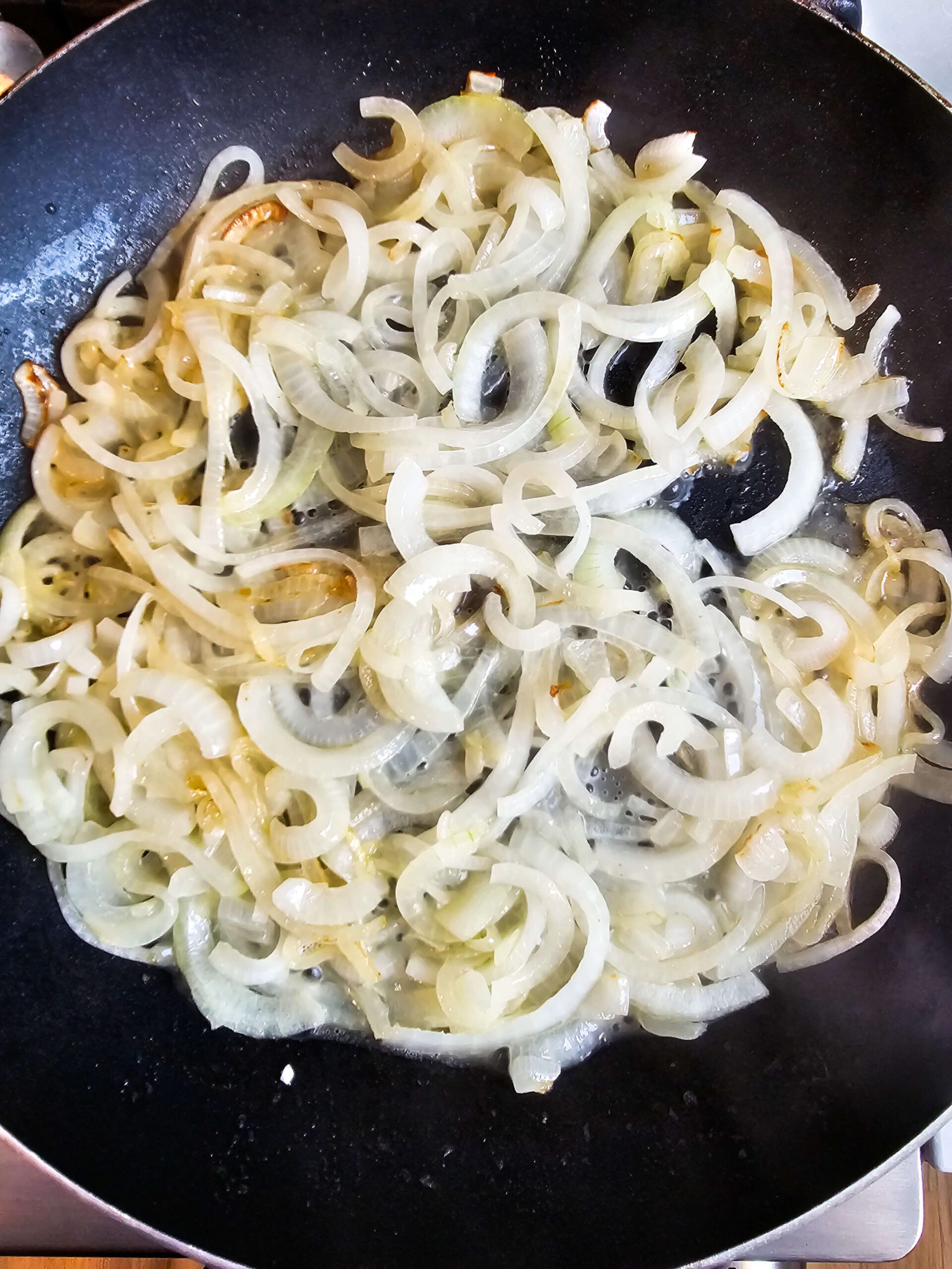 SKILLET FILLED WITH ONIONS AND GARLIC- SAUTE UNTIL SOFTENED