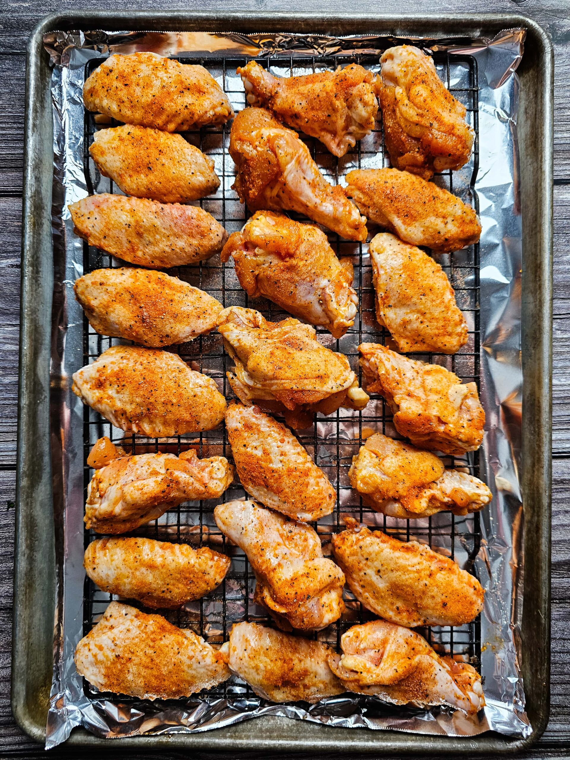 ARRANGE SEASONED CHICKEN WINGS ON BACKING RACK