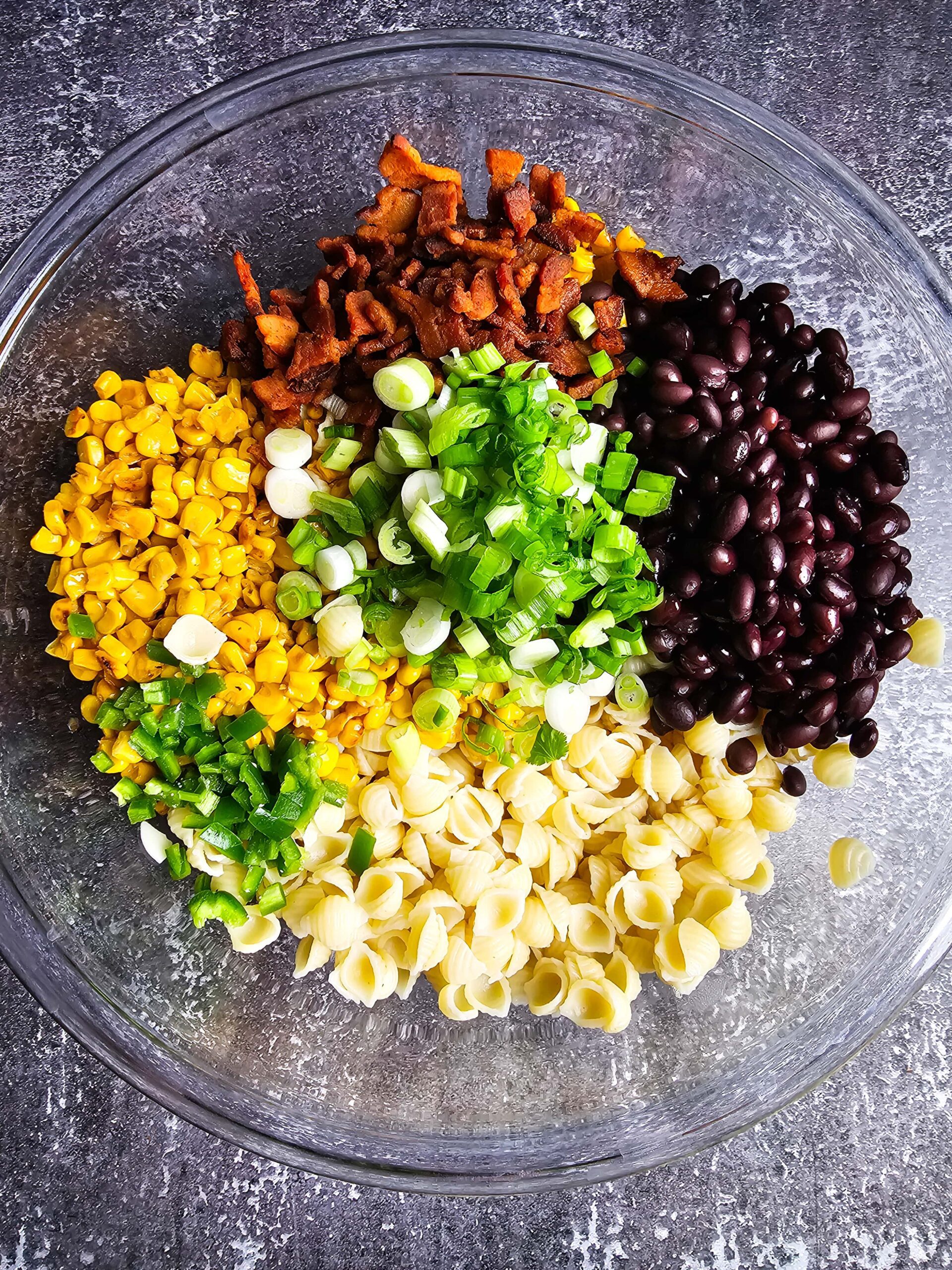 BOWL FULL OF COOKED PASTA AND CHOPPED VEGETABLES