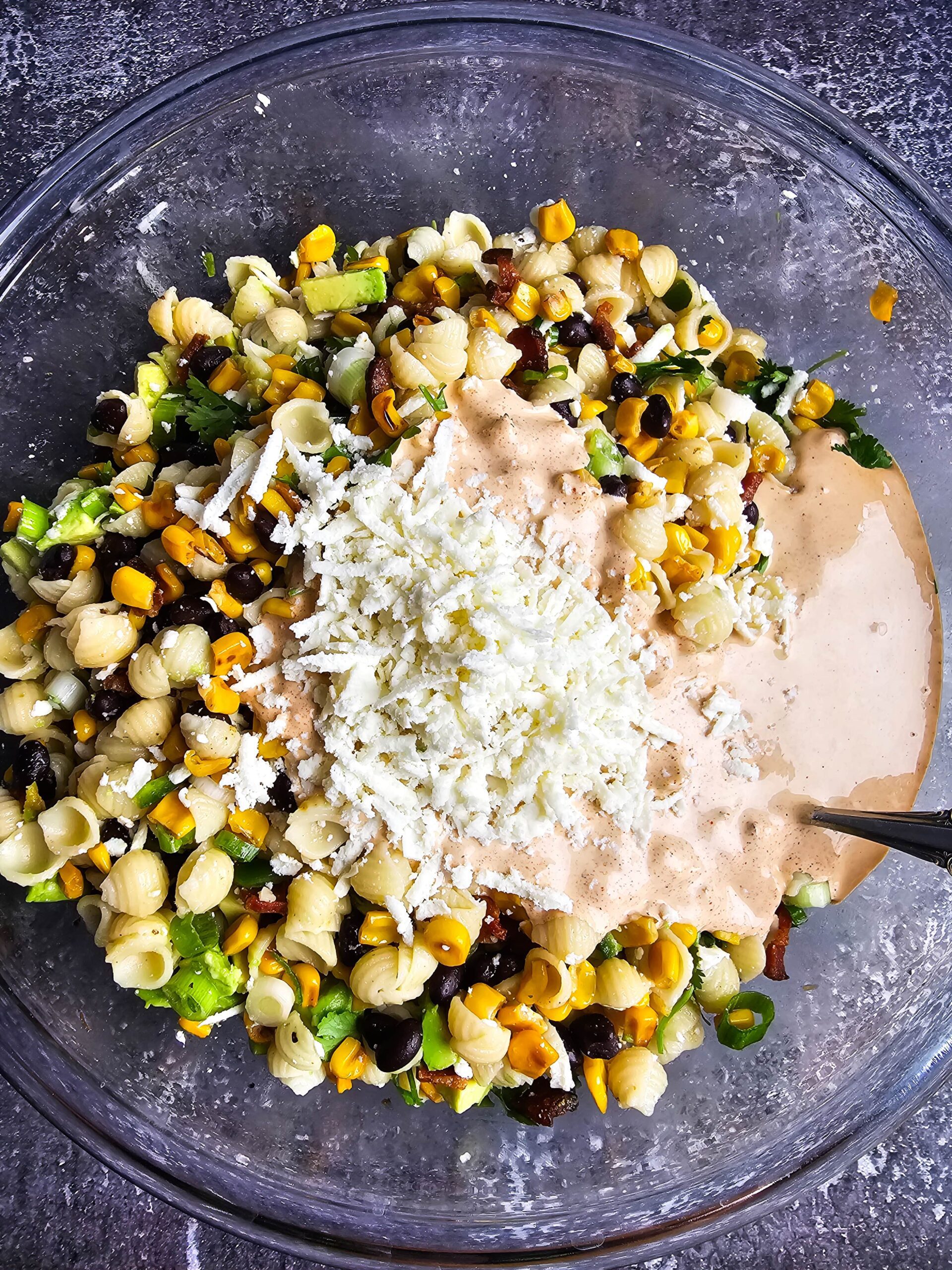 ADD THE DRESSING AND CHEESE TO THE LARGE BOWL