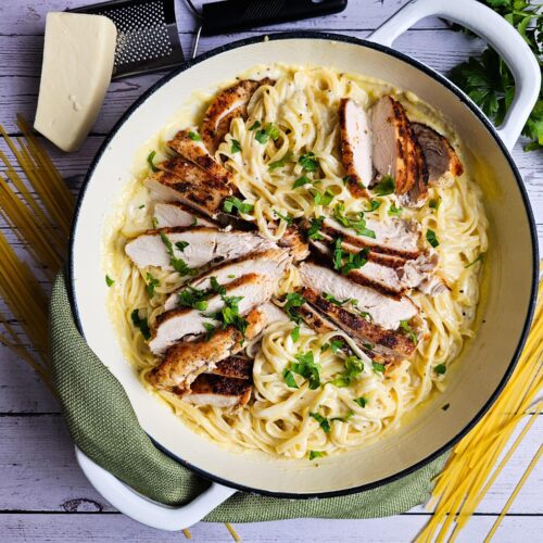 LARGE SKILLET CREAMY PARMESAN PASTA CHICKEN GARNISHED WITH PARSLEY