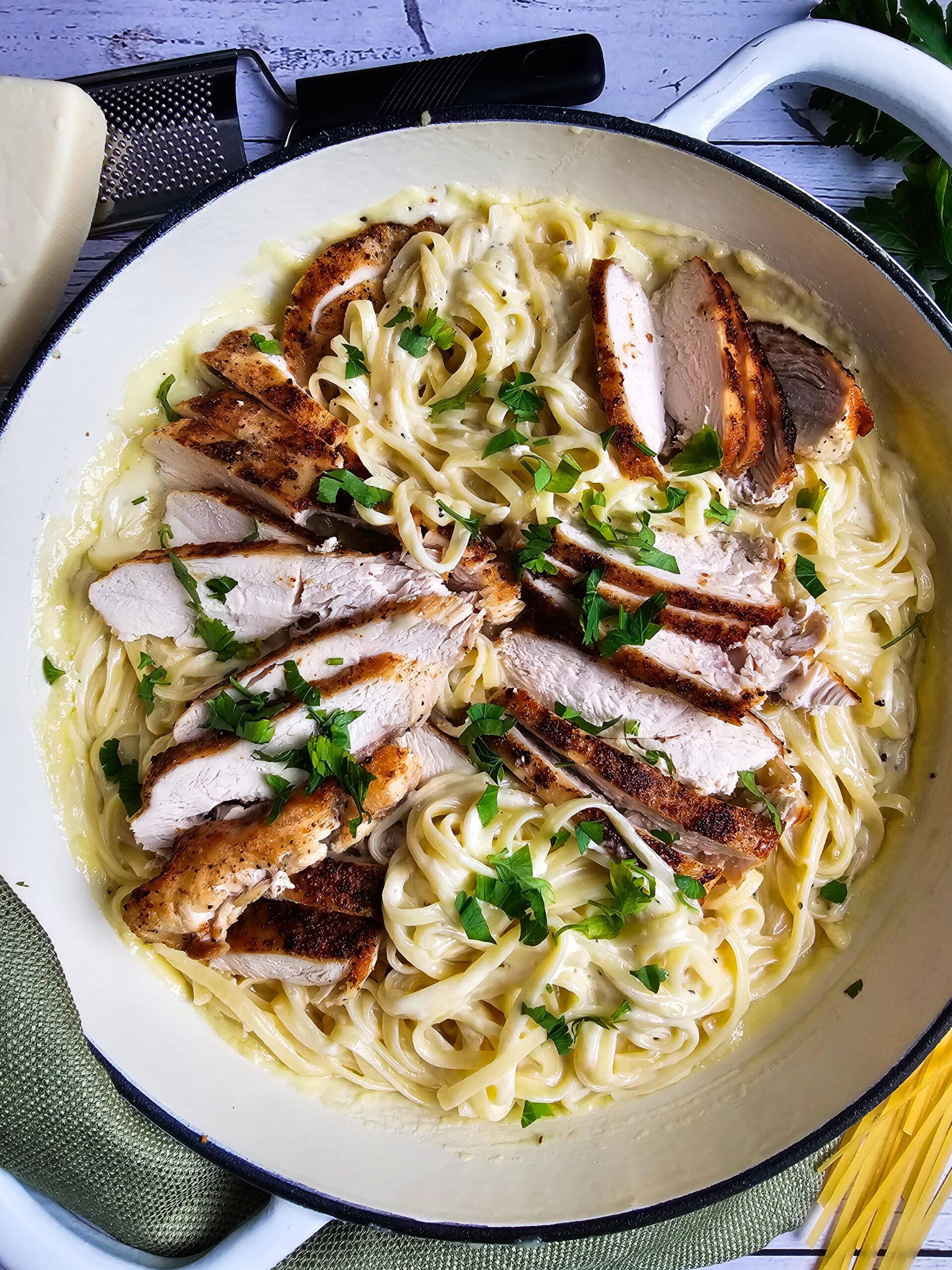 IN THE SKILLET COMBINE THE SAUCE, FETTUCCINI NOODLES AND SLICED CHICKEN AND GARNISHED WITH FRESH PARSLEY.