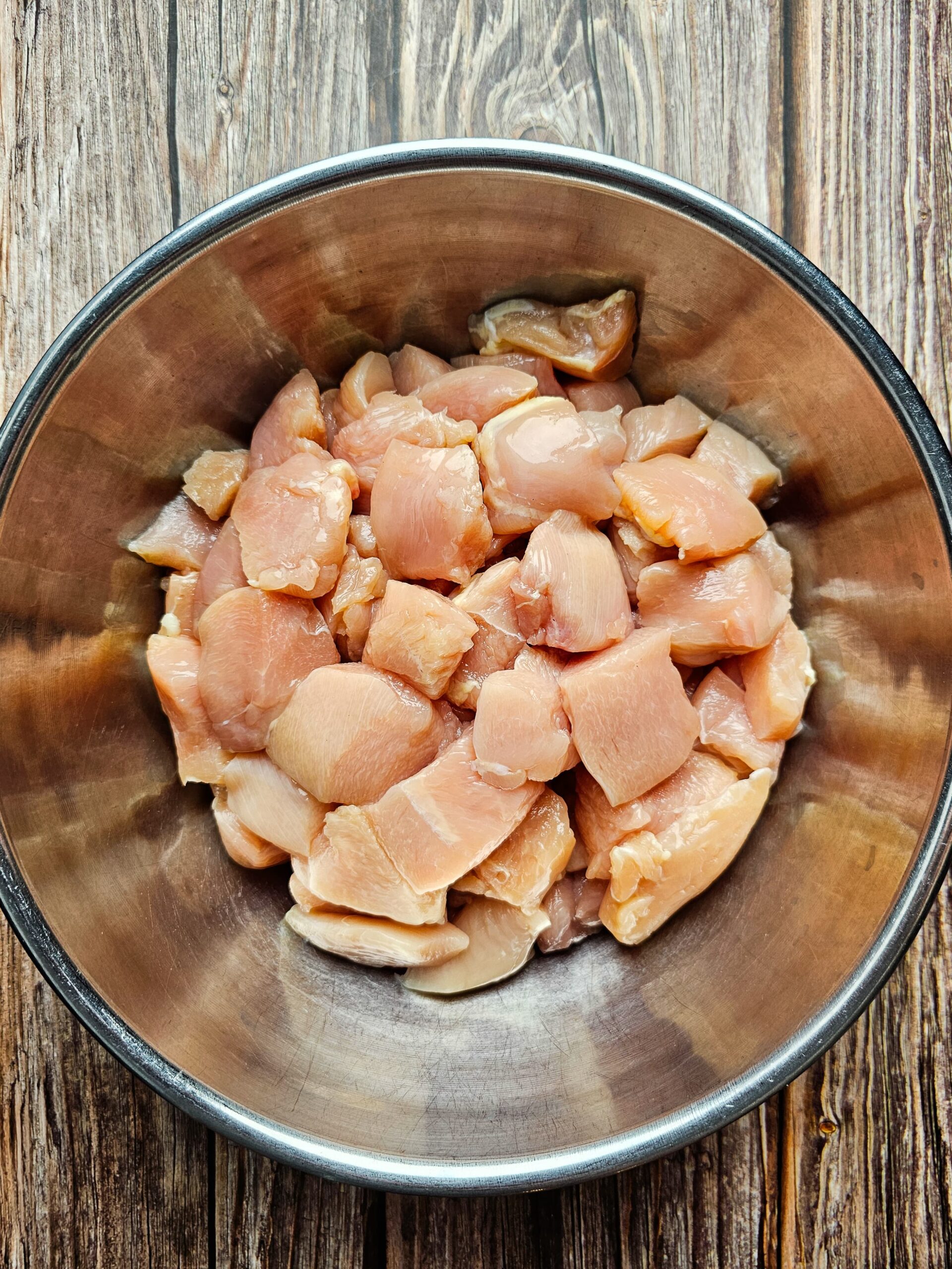 CUBED CHICKEN IN A STAINLESS STEAL BOWL