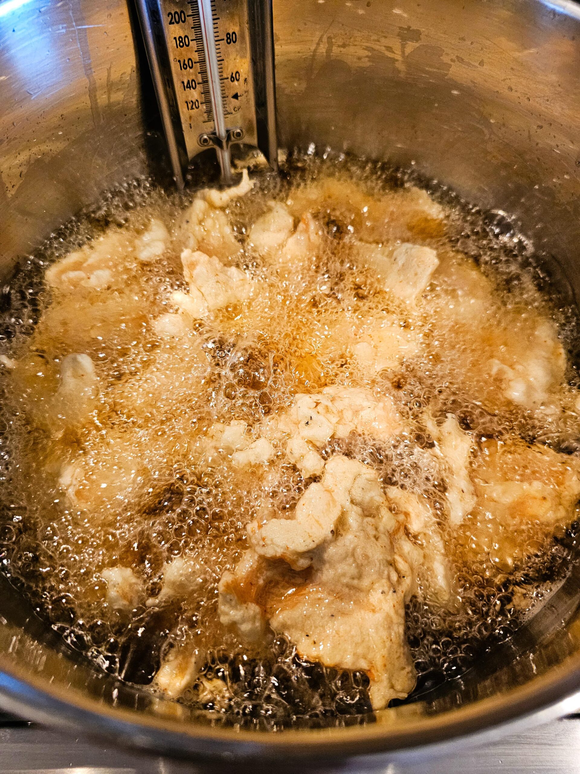 BATTERED CHICKEN FRYING IN OIL