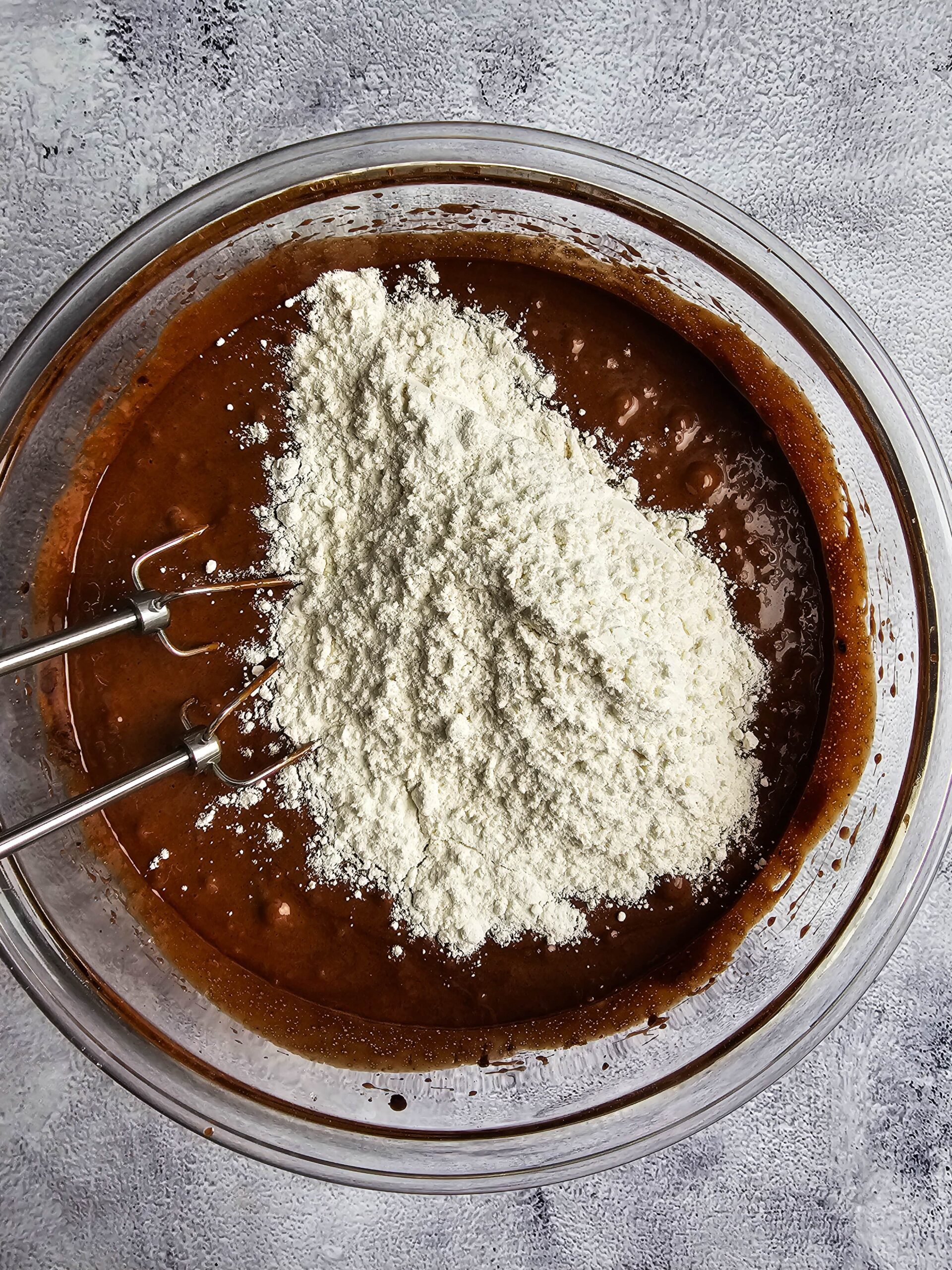 LARGE BOWL WITH WET INGREDIENTS ADDING THE DRY INGREDIENTS