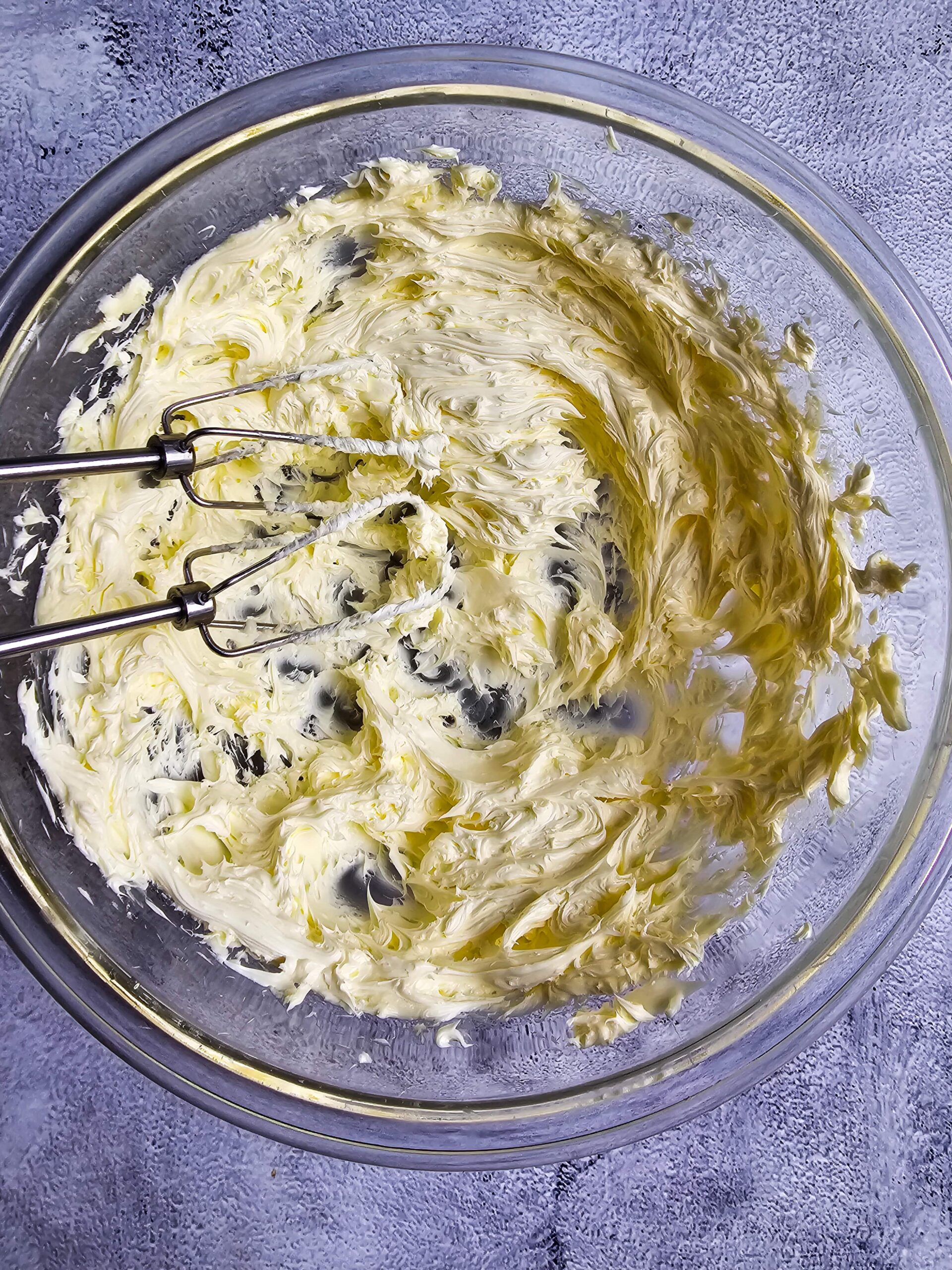 LARGE GLASS BOWL AND CREAM THE BUTTER AND SUGAR TOGETHER