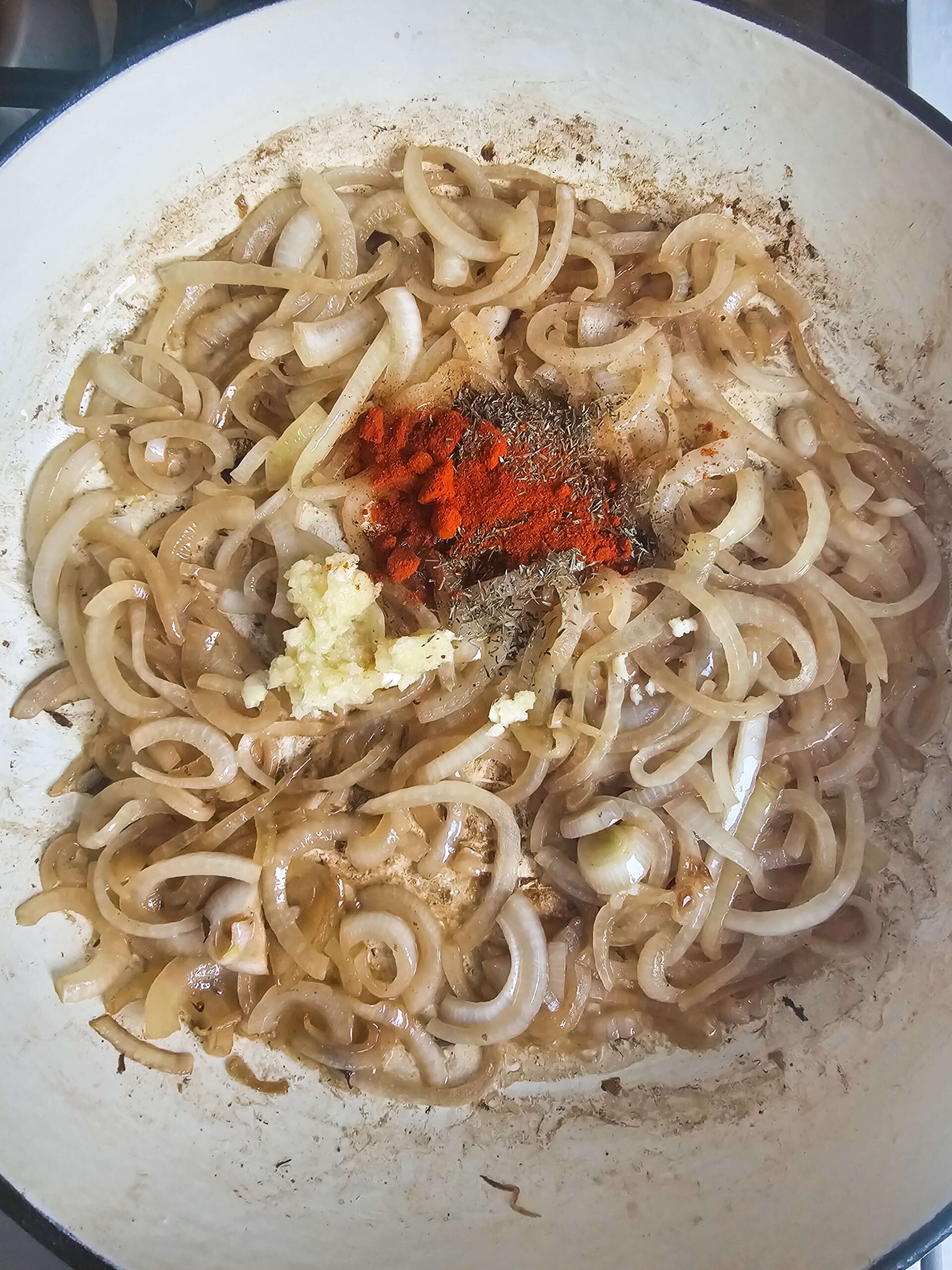 IN THE CAST ENAMAL SKILLET SAUTE THE ONIONS, GARLIC AND SEASONINGS