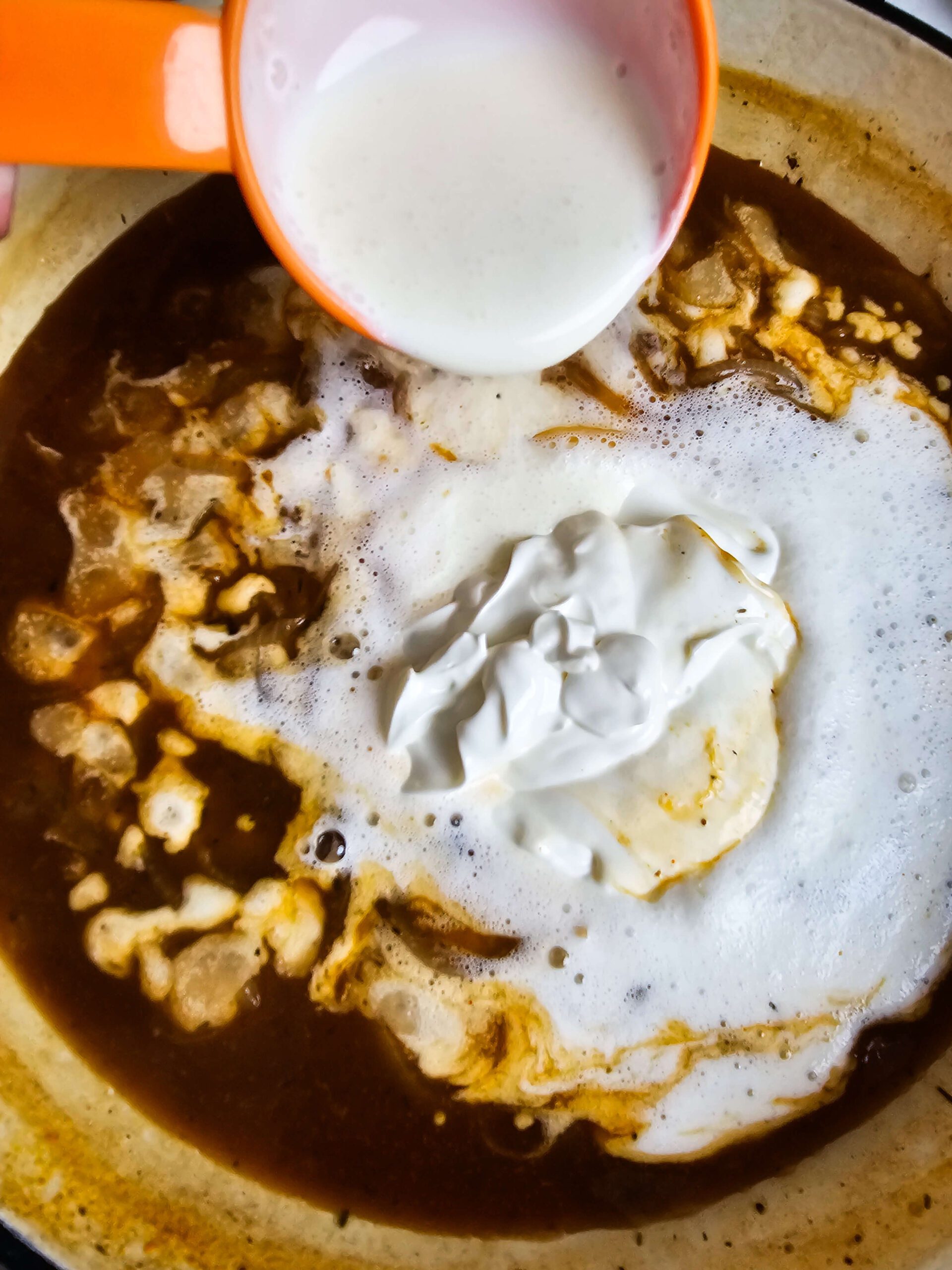 ADD THE HEAVY CREAM AND THE SOUR CREAM AND STIRRING UNTIL IT THICKENS AND CREAMY