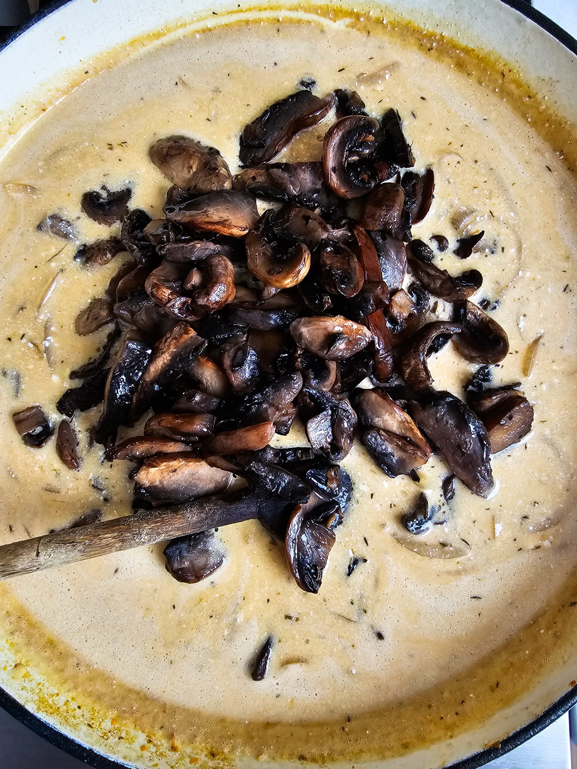ADDING THE MUSHROOMS BACK TO THE CREAMY SAUCE