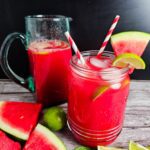 TALL PITCHER FILLED WITH LIMEADE AND MASON JAR GARNISHED WITH WATERMELON SLICES