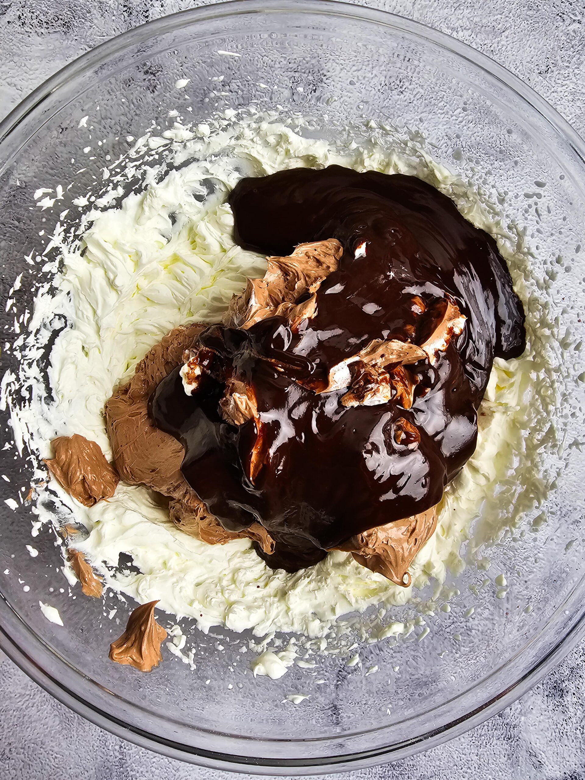 WHIP TOGETHER THE CREAM CHEESE, CHOCOLATE MIXTURE, COCO POWDER AND WHIPPED HEAVY CREAM