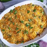 ZUCCHINI CASSEROLE IN A WHITE CASSEROLE DISH GARNISHED WITH PANKO BREADCRUMBS AND FRESH PARSLEY