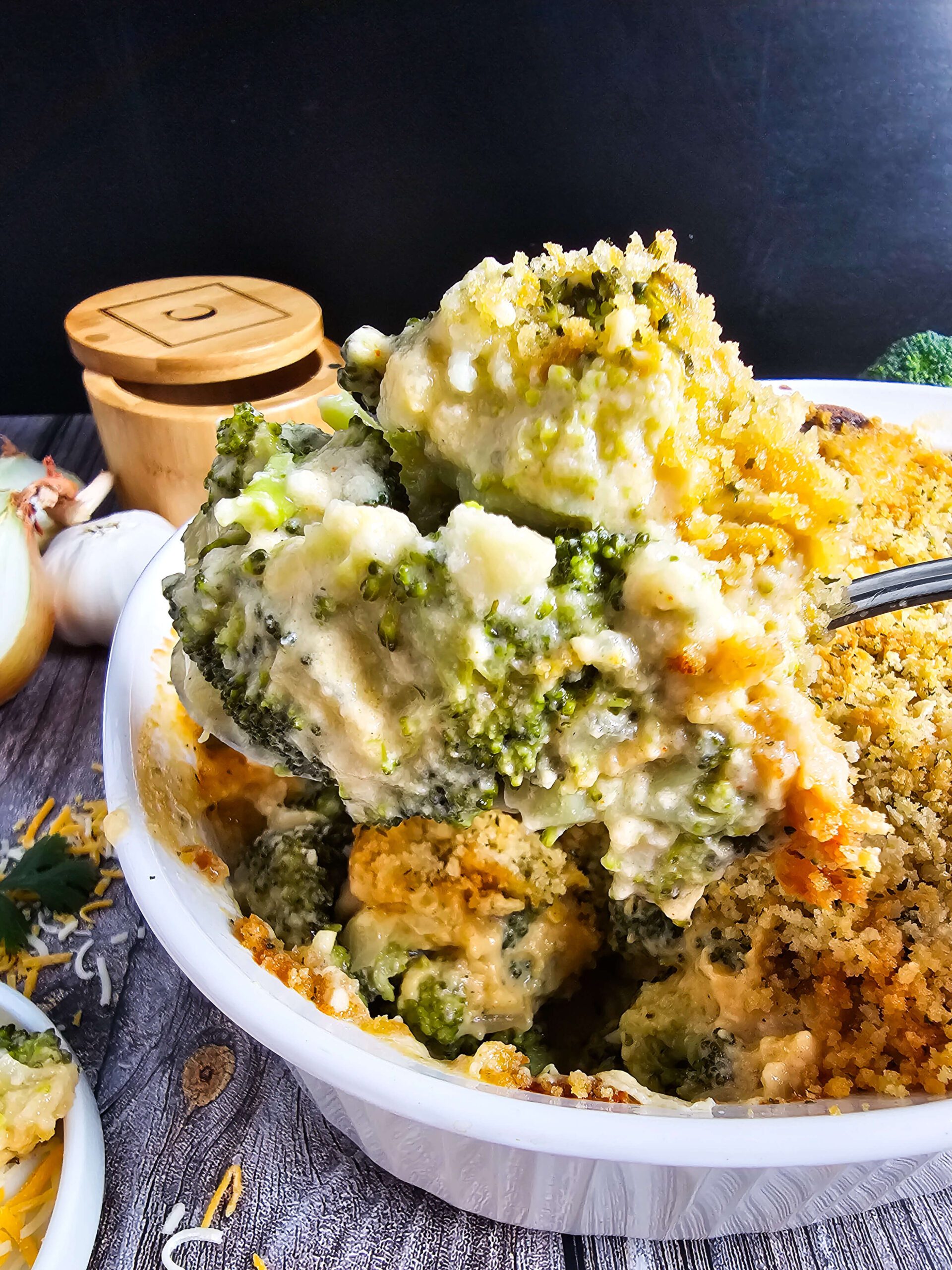 BAKE A SERVE THE CASSEROLE -- PHOTO OF LARGE SERVING SPOON FULL OF CREAMY BROCCOLI CASSEROLE