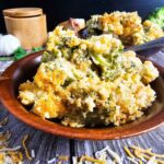 PLATE FULL OF CREAMY BROCCOLI CASSEROLE IN A RED SERVING PLATTER