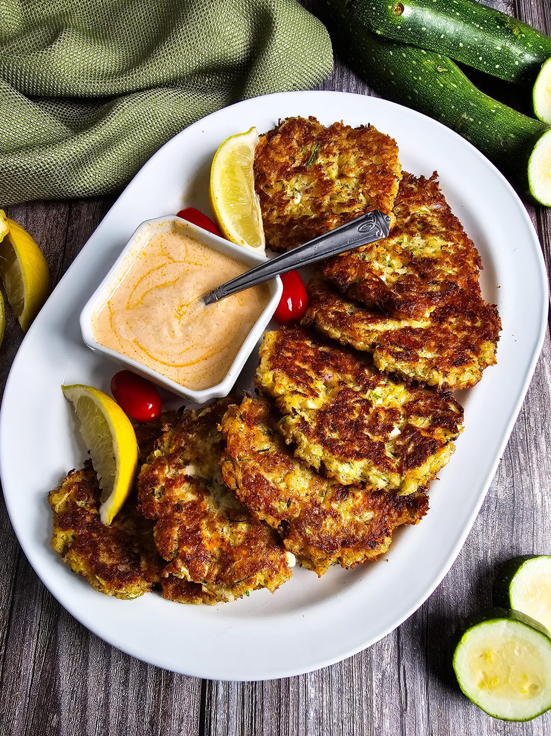 LARGE SERVING PLATTER WITH ZUCCHINI FRITTERS PAIRED WITH THE SMOKY YOGURT SAUCE