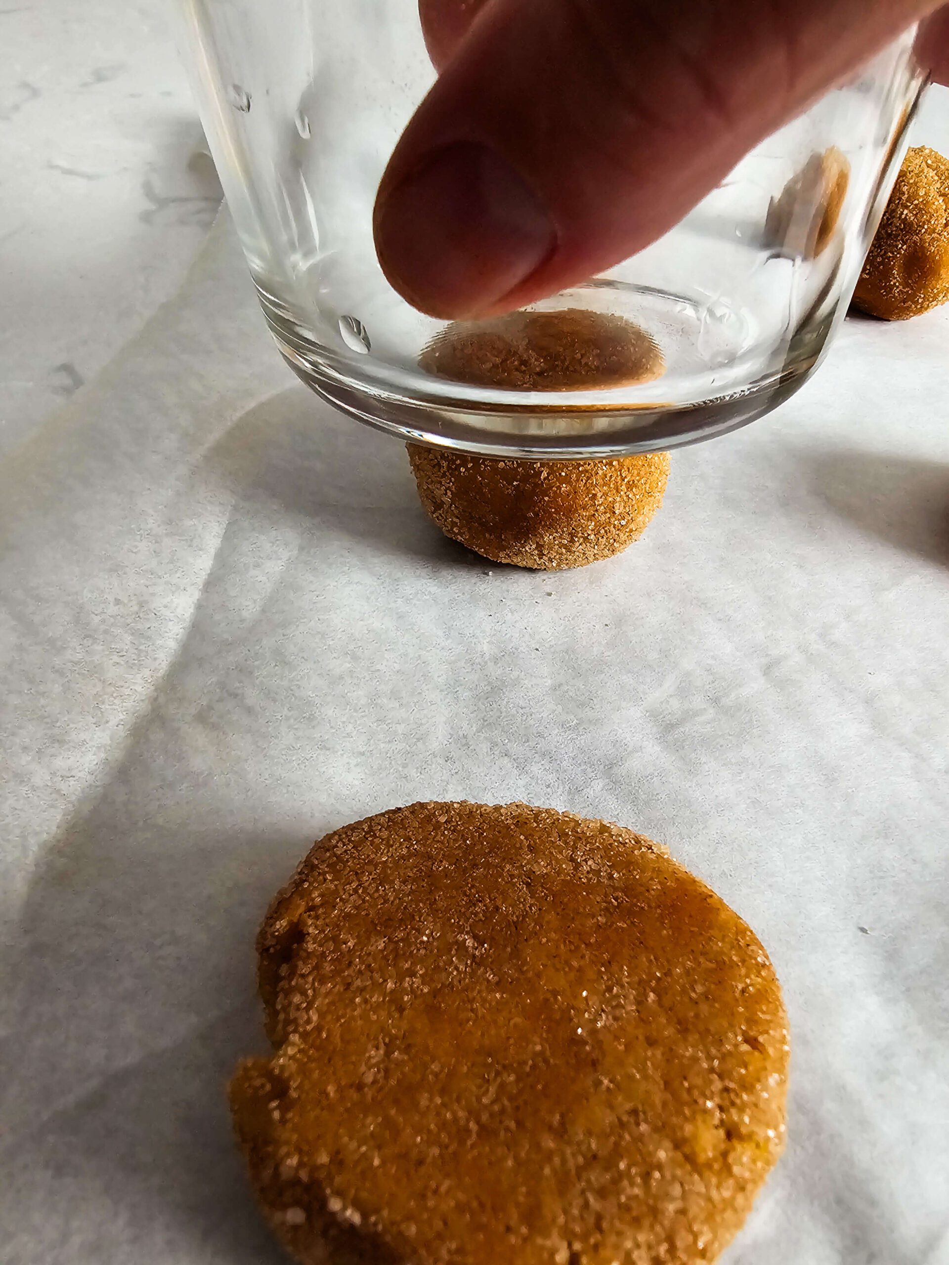 FLATTEN THE DOUGH BALLS WITH THE BOTTOM OF A GLASS TO SLIGHTLY FLATTEN THEM