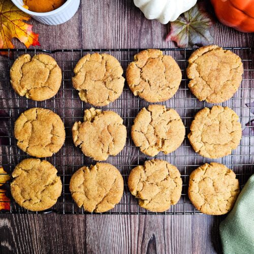 12 COOKIES COOLING ON A WIRE COOKIE RACK ON A RUSTIC WOODEN TABLE