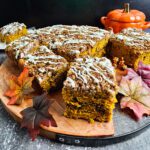 PUMPKIN COFFEE CAKE SLICED ON A WOODEN CUTTING BOARD