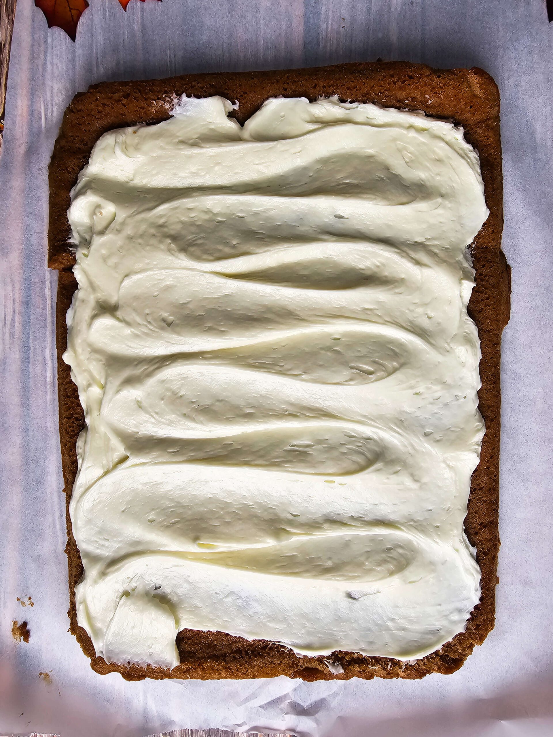 EVENLY SPREAD THE FILLING ON THE COOLED PUMPKIN SPICE CAKE