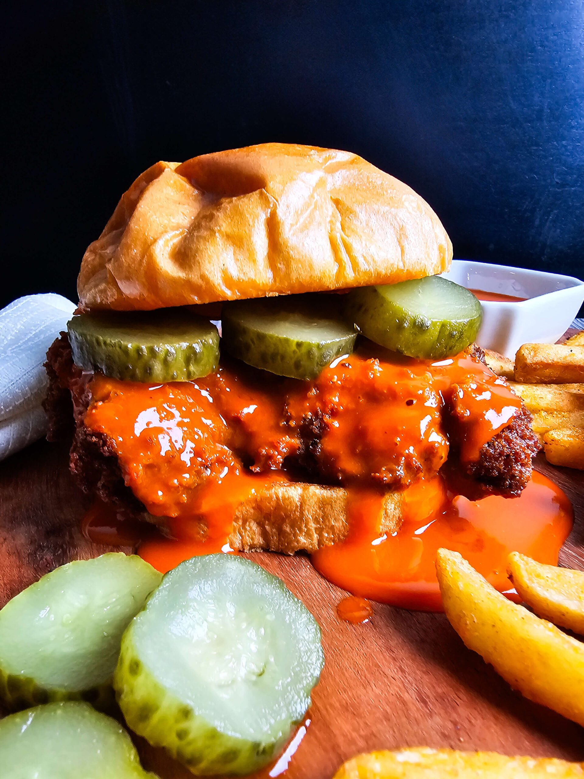 ASSEMBLE THE BUFFALO CHCIKEN ON TOASTED BRIOSH BUN WITH PICKLES