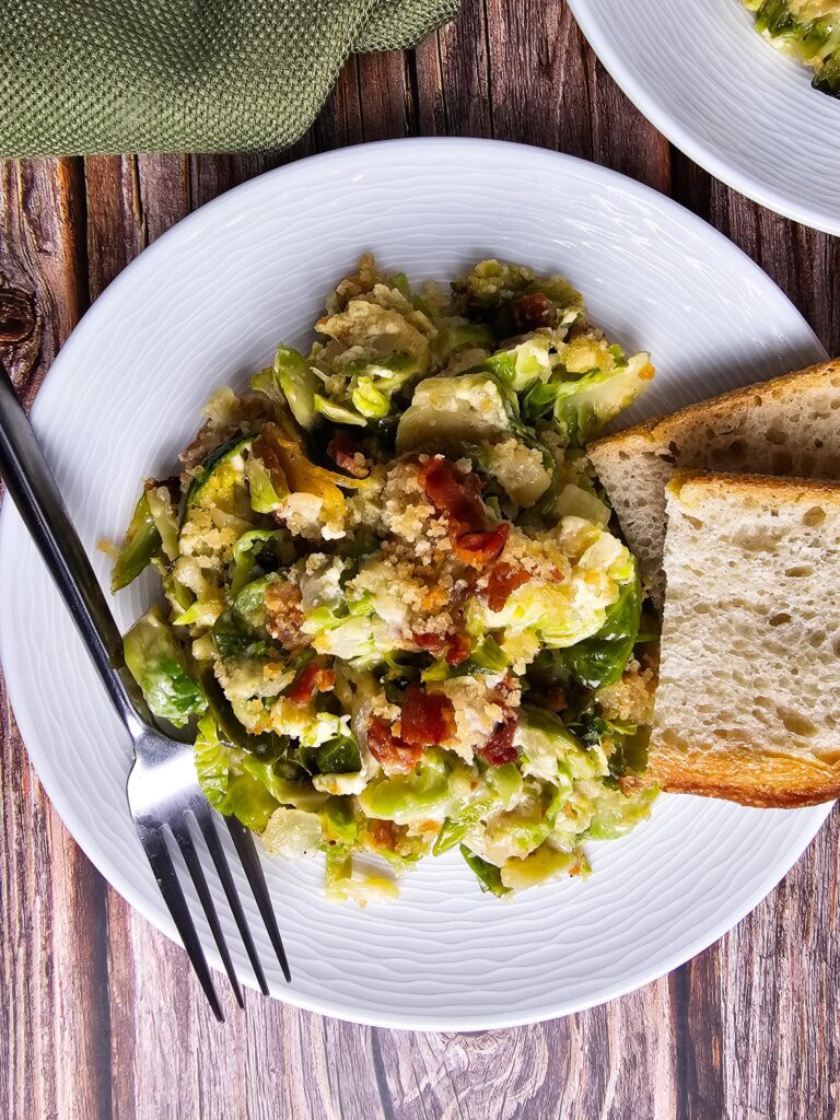 PLATED BRUSSELS SPROUTS CASSEROLE WITH A SIDE OF TOASTED SOUR DOUGH BREAD