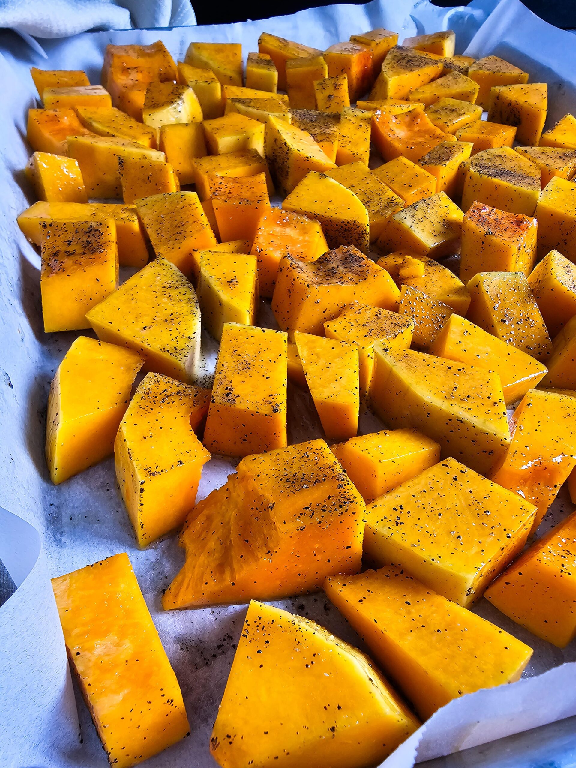 PEEL, CUBE, AND REMOVE SEEDS FORM THE BUTTERNUT SQUASH AND ARRANGE ON A BAKING SHEET.