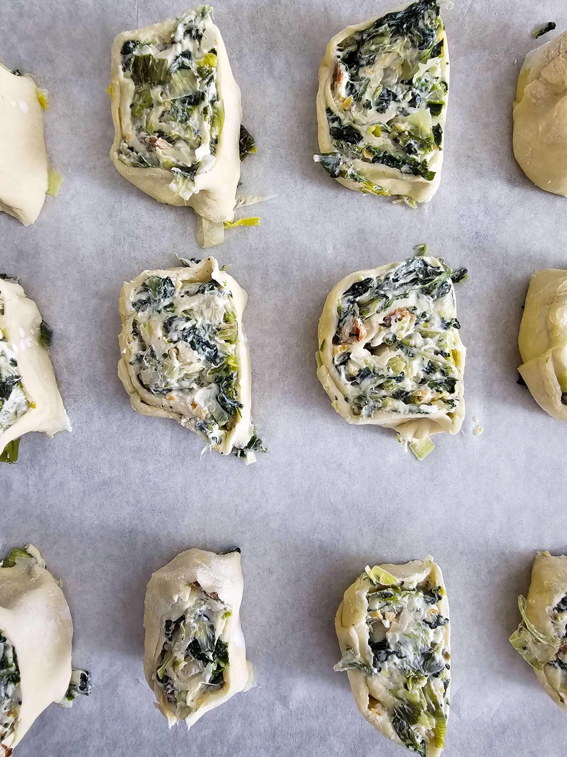 ROLL AND SLICE THE PUFF PASTRY AND BRUSH WITH THE BEATEN EGG WASH