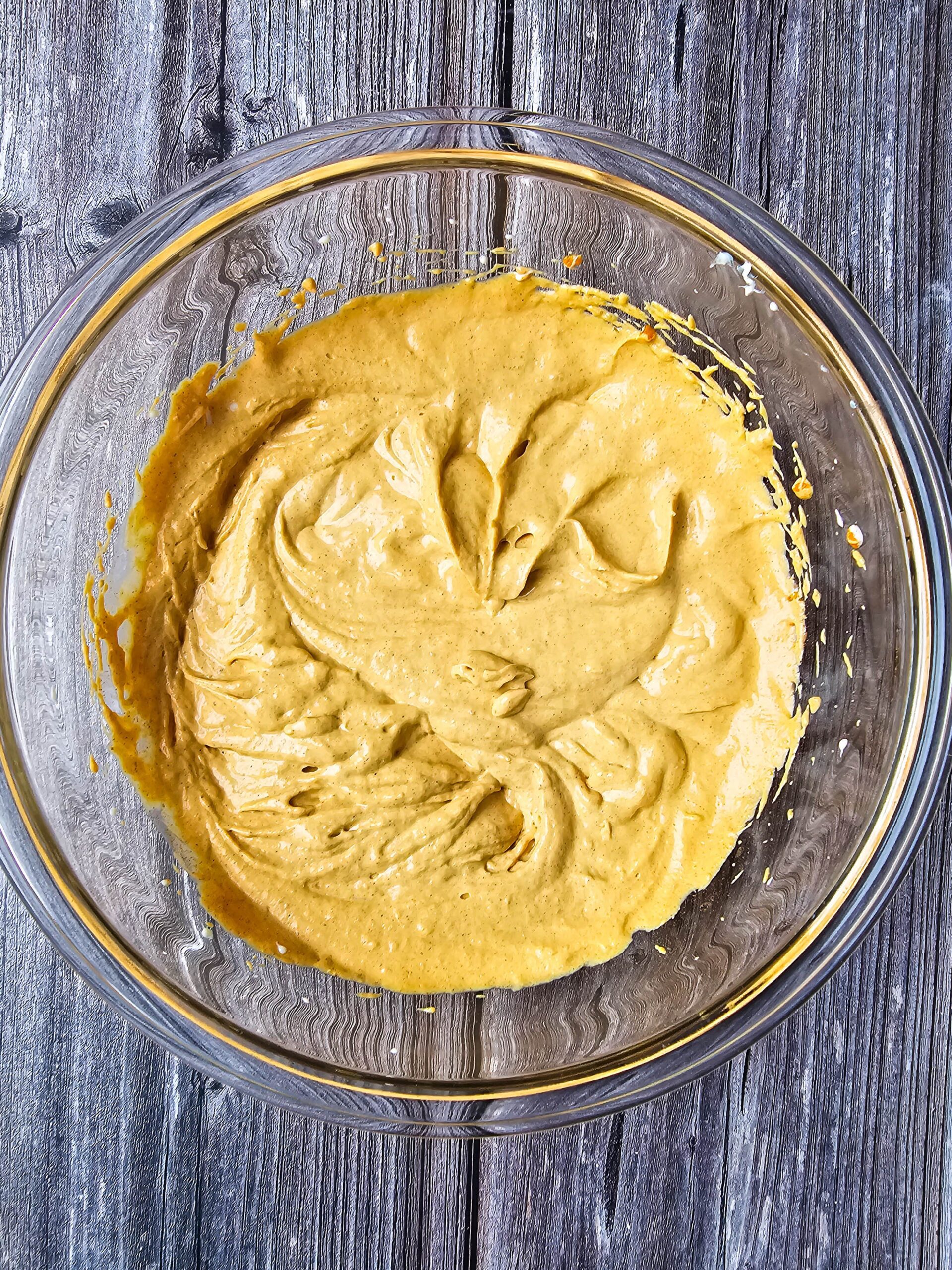 large bowl with the pumpkin cheesecake flavored part of the filling