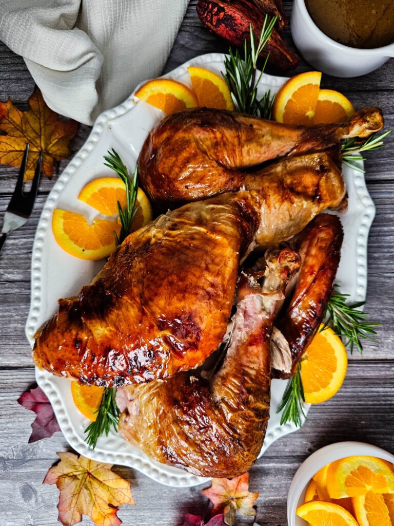 CARVED TURKEY ON A LARGE WHITE SERVING PLATTER.