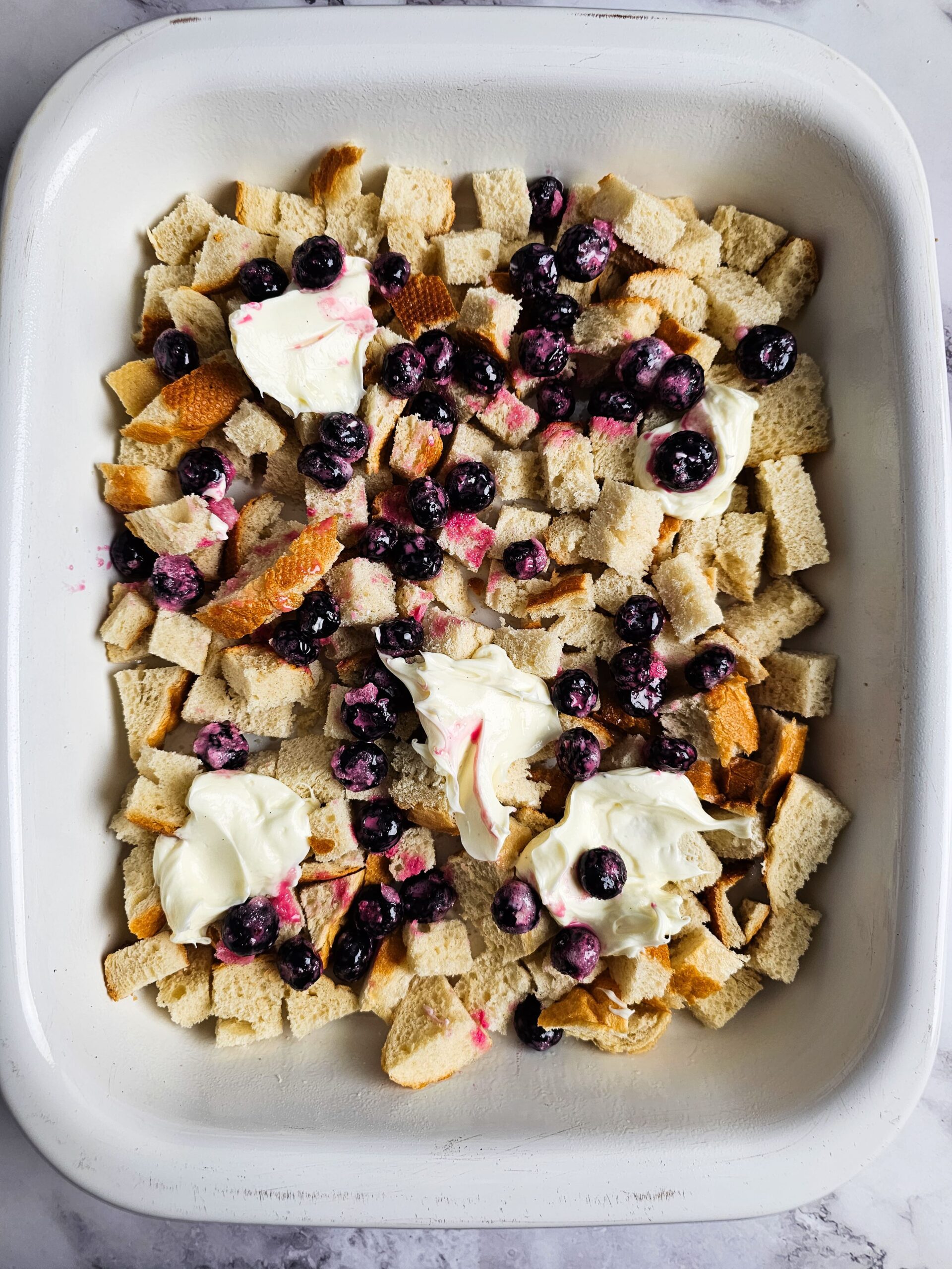 LAYER THE CHEESECAKE DOLLOPS AND BLUEBERRIES