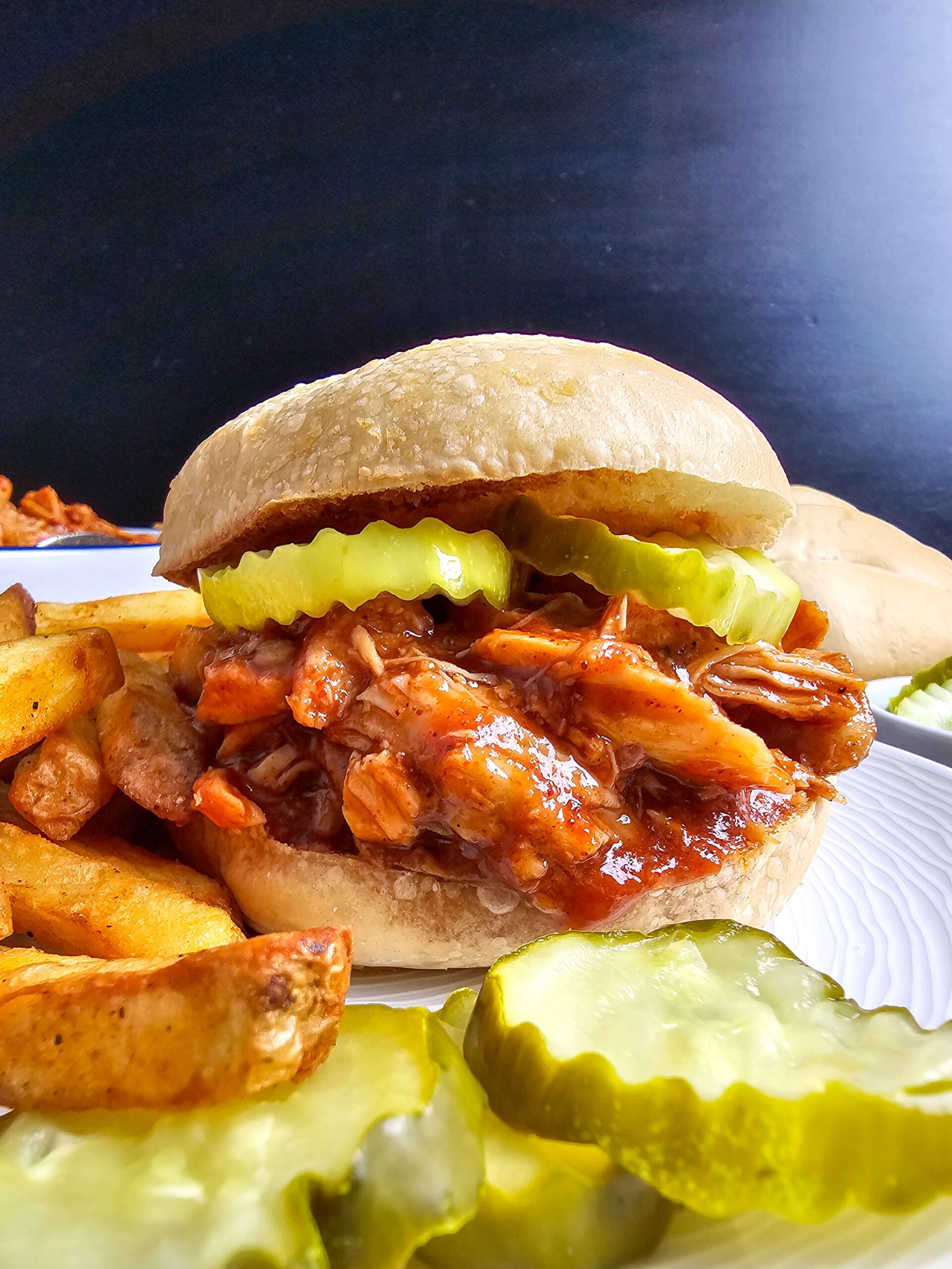 SERVE THE PULLED CHICKEN ON A TOASTED BUN WITH PICKLES OR COLE SLAW