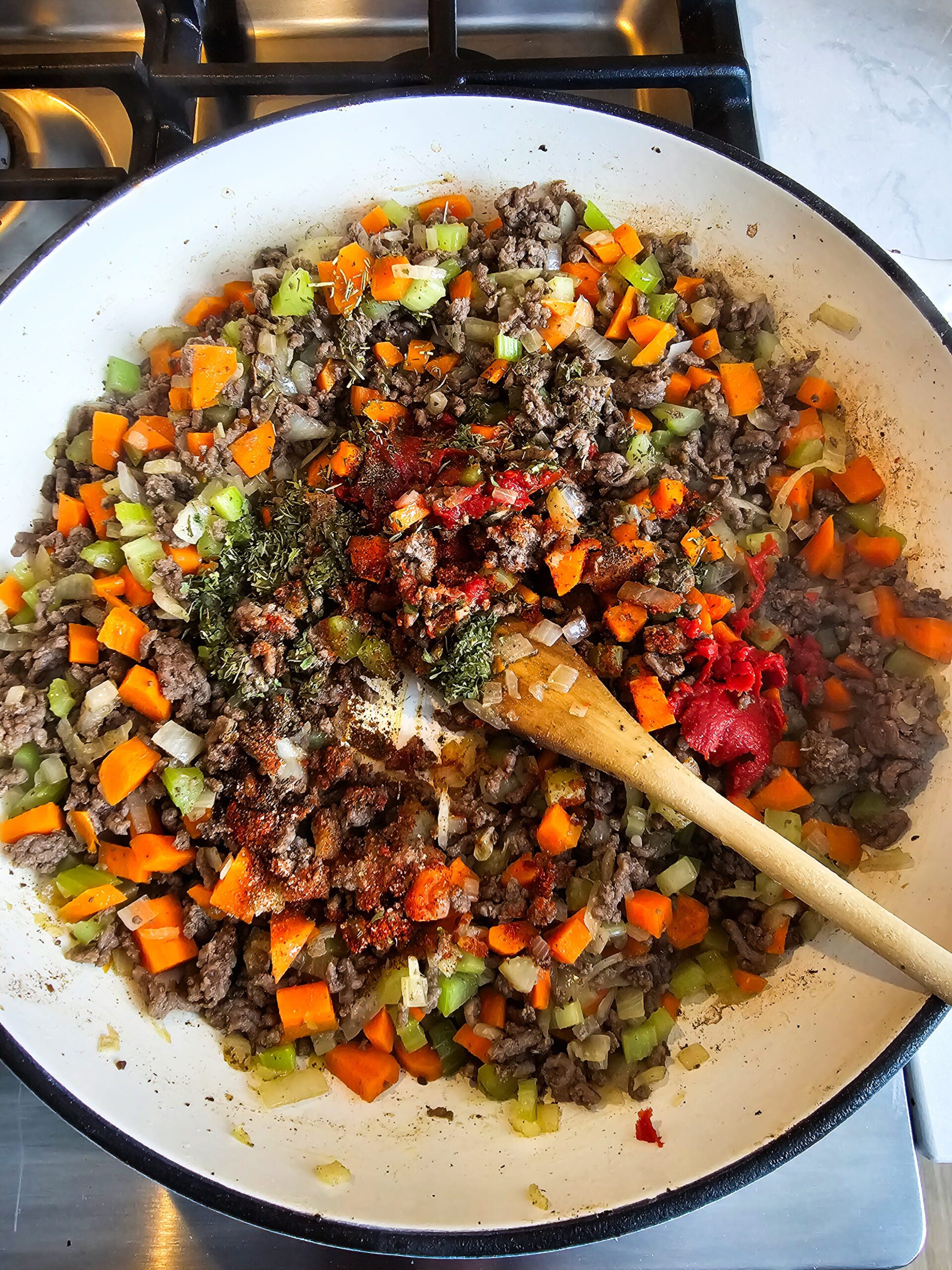 ADD THE SPICES AND THE TOMATOE PASTE TO BLOOM THE SPICES AND INTENSIFY THE FLAVOR
