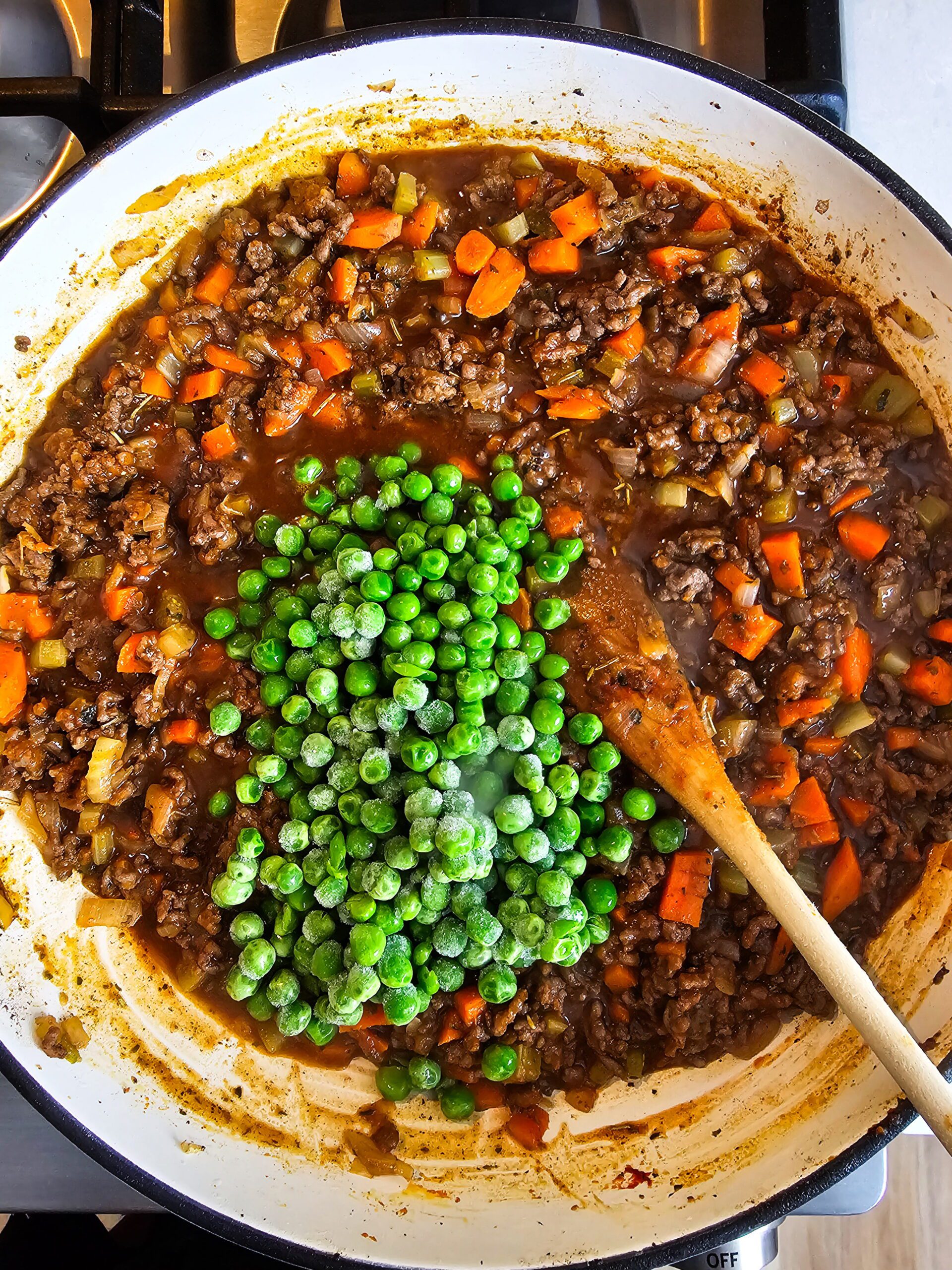 ADD THE BEEF BROTH AND THE FROZEN PEAS