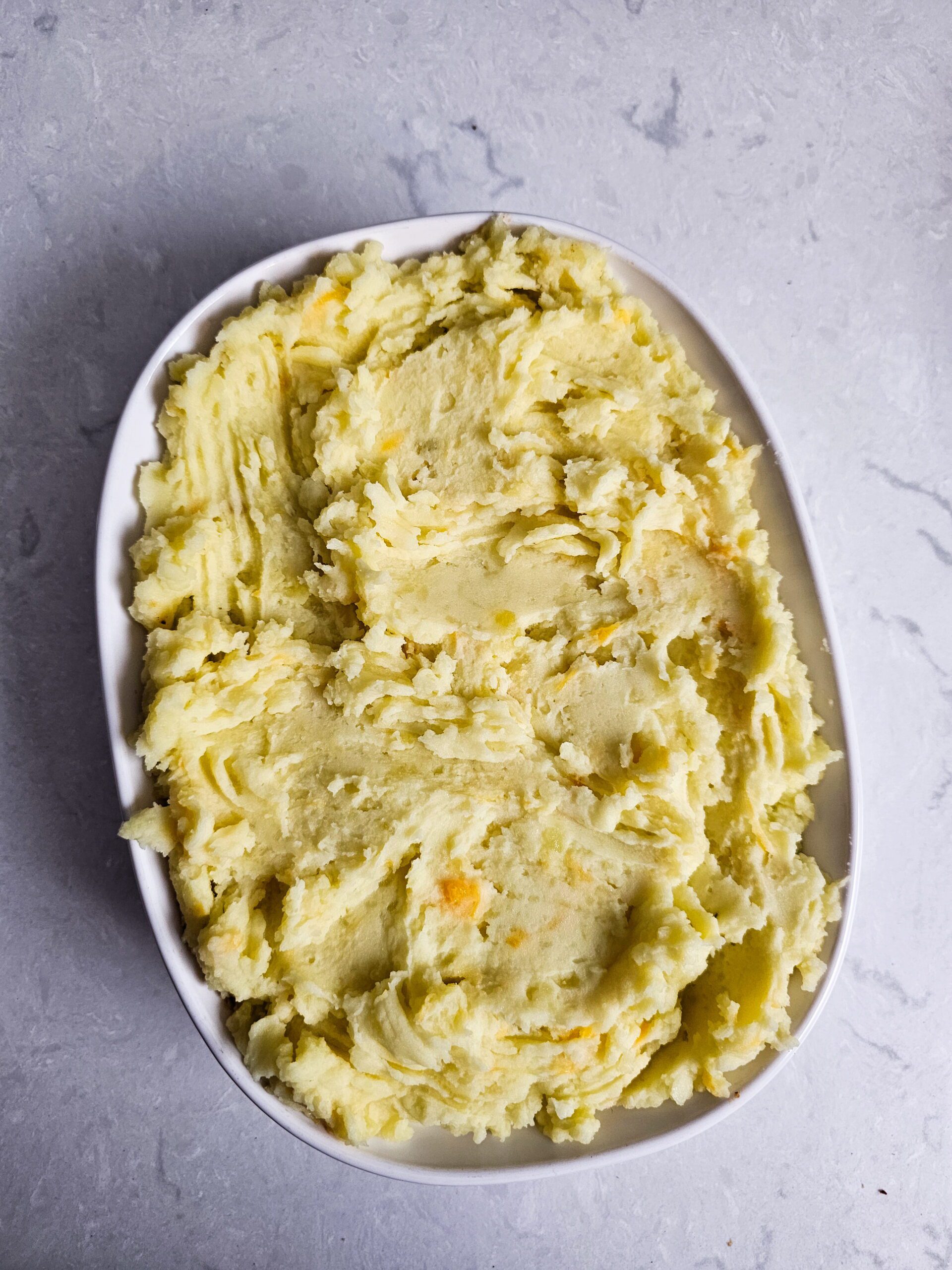 SPREAD THE BEEF MIXTURE AND THE MASHED POTATOES ON TOP.