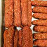 hand shaping Serbian cevapi sausages into finger sized logs 3 inches long and 1 inch thick