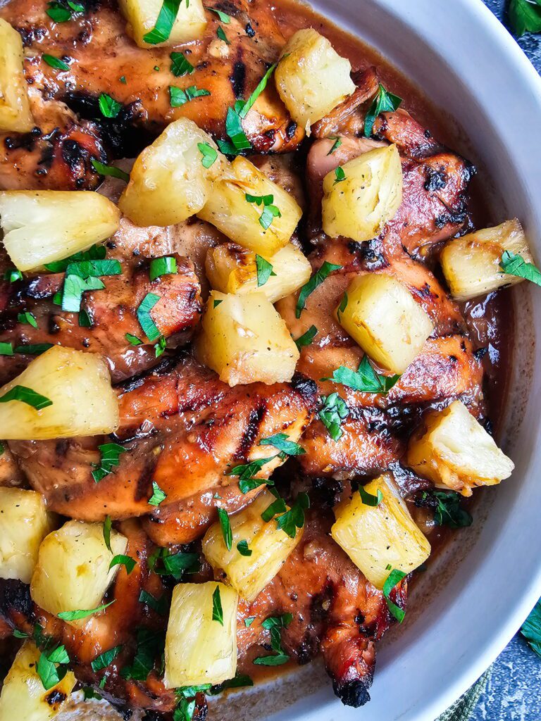 huli huli chicken recipe served on a platter with grilled pineapple