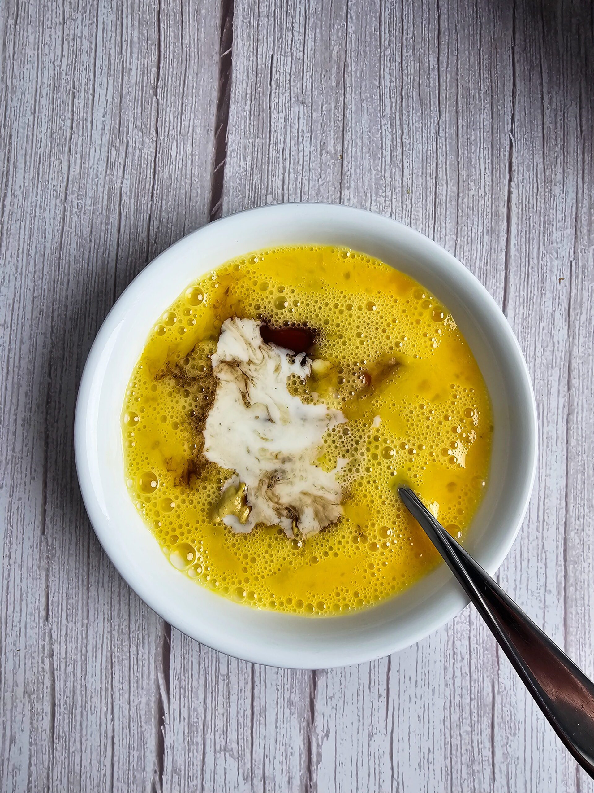 Whisking eggs, ketchup, Dijon mustard and Worcestershire sauce together in a large bowl