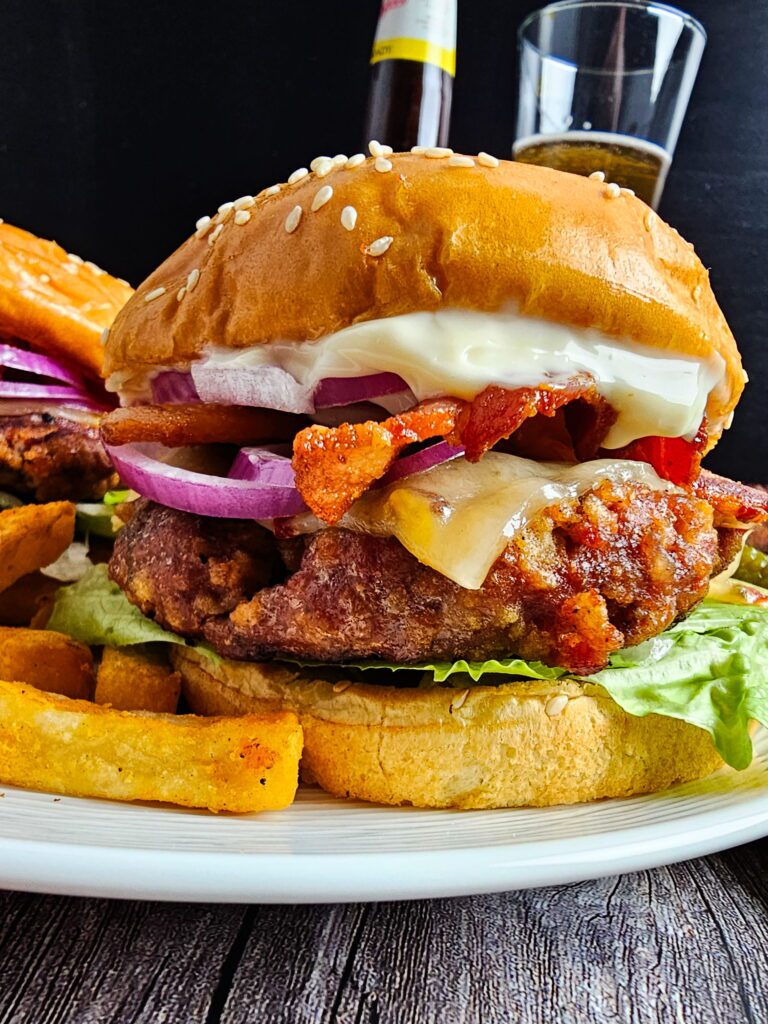Juicy turkey burger on a toasted brioche bun with lettuce, tomato and red onion