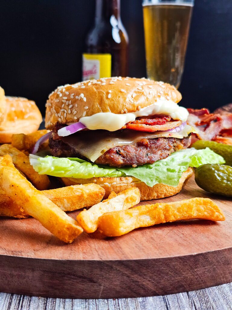 Juicy turkey burger on a toasted brioche bun with lettuce, tomato and red onion