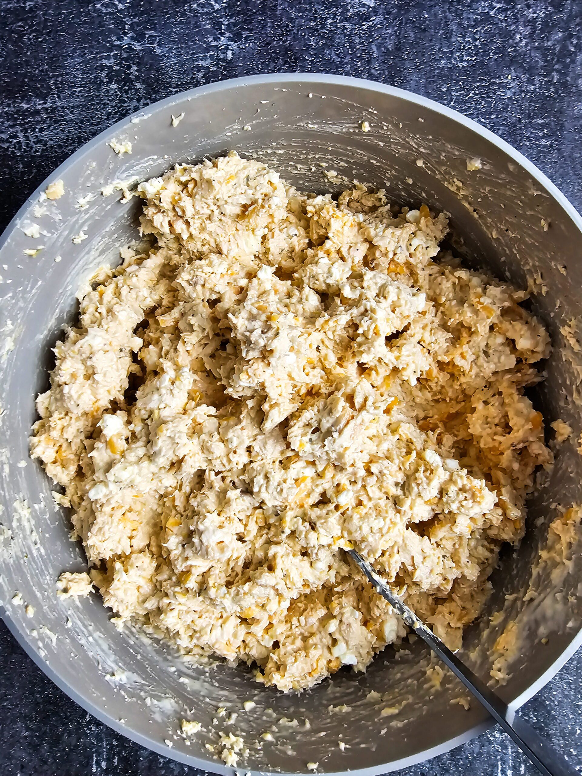 folding chicken into creamy casserole filling