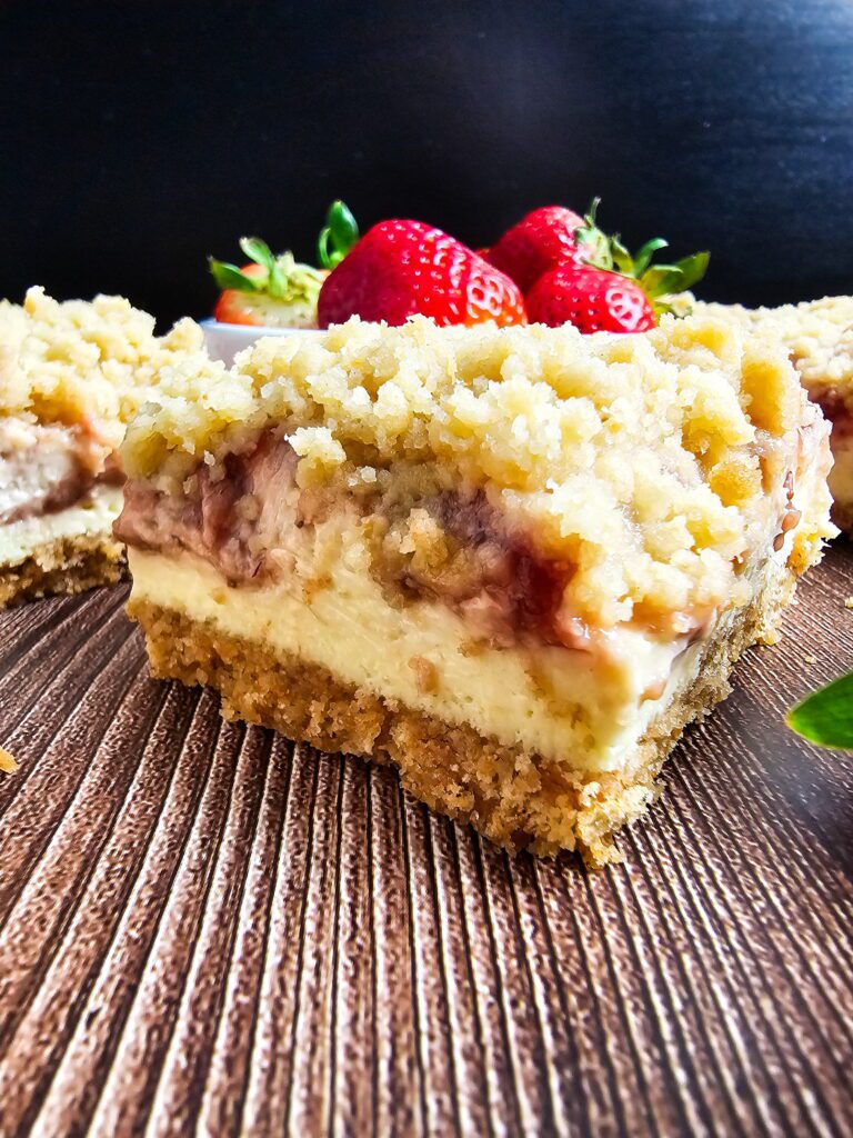 strawberry cheesecake bars with crumble topping on plate