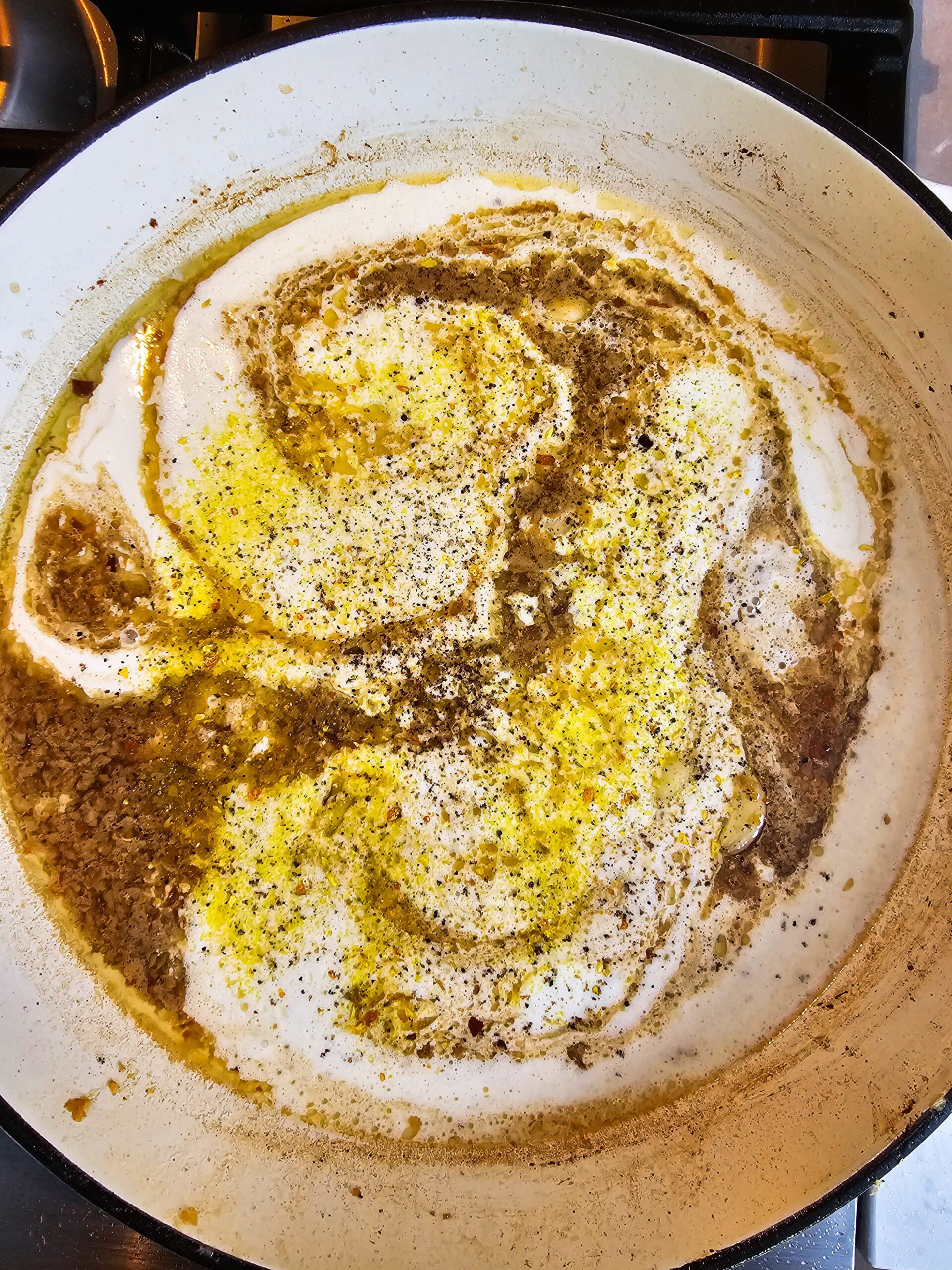 Deglazing the skillet with chicken broth scraping up caramelized fond for restaurant style creamy garlic chicken sauce 