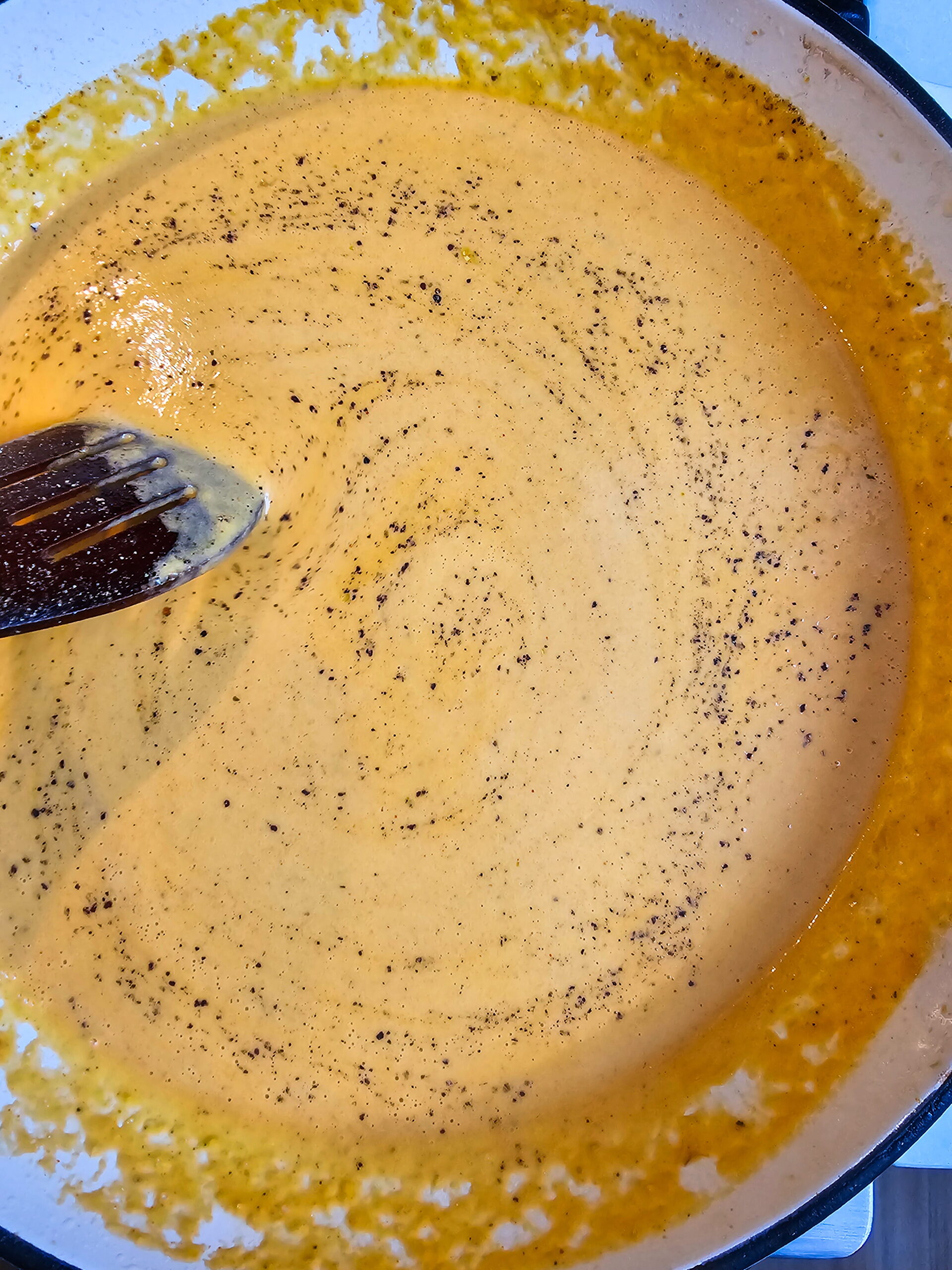 Cream sauce simmering in skillet with smoked paprika