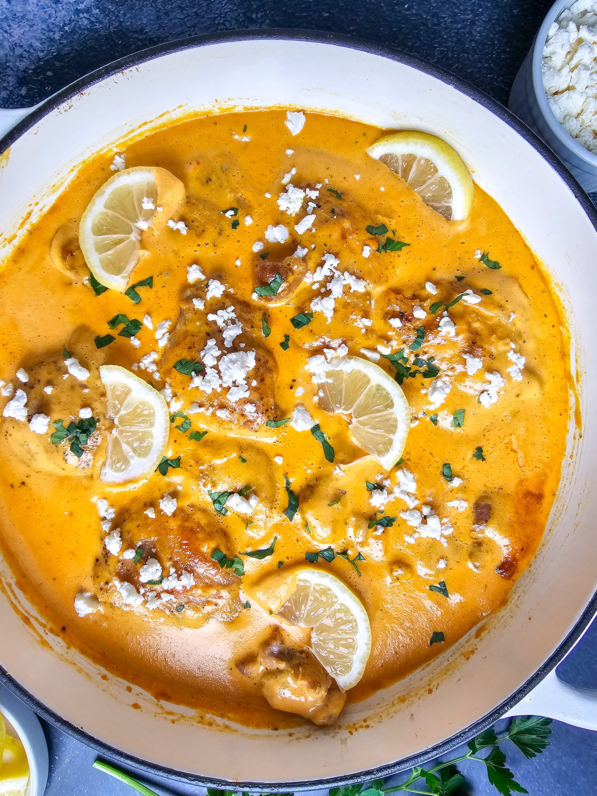 Skillet dish with goat cheese and fresh parsley ready to serve